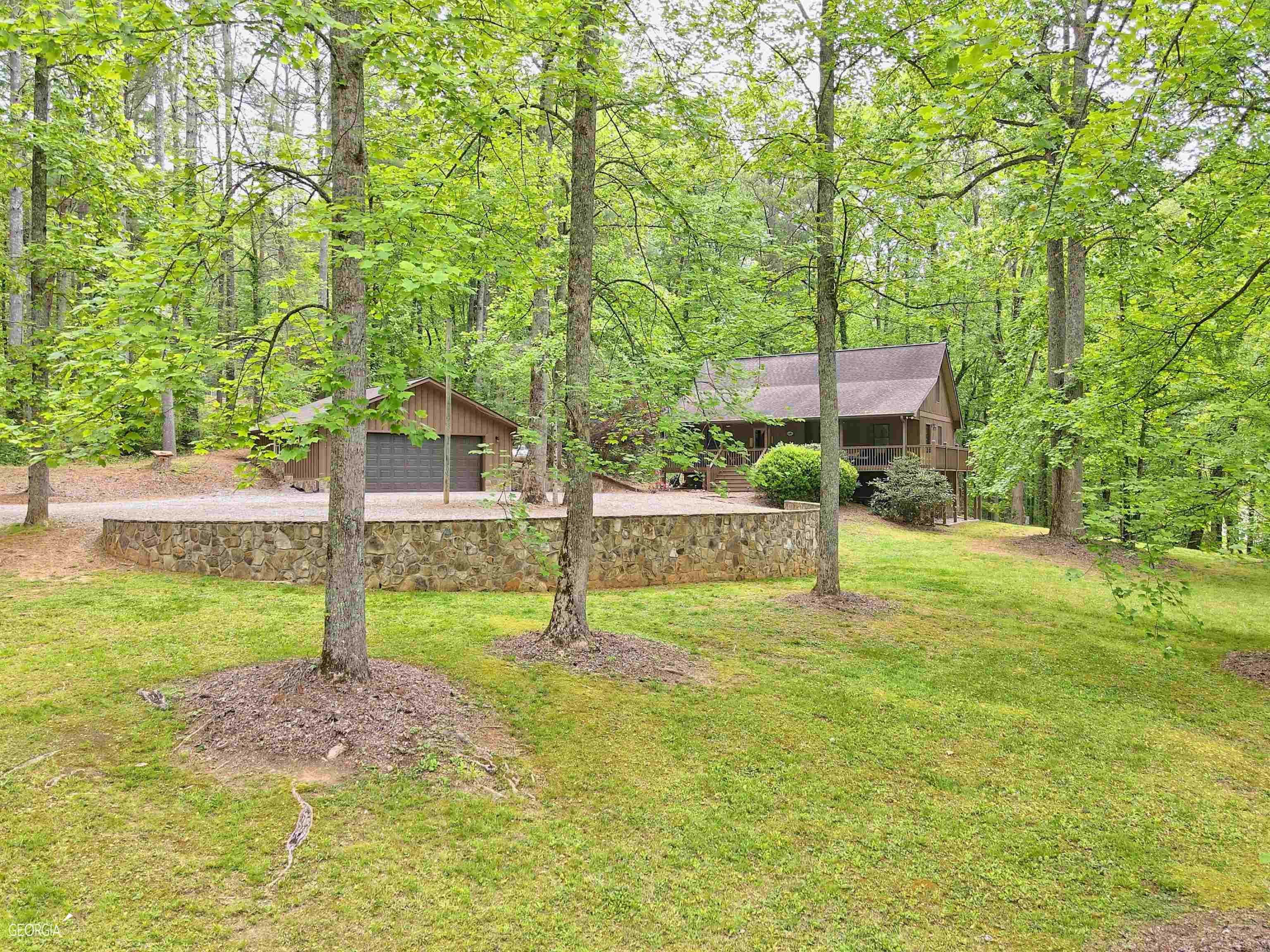 50 Parker Hollifield Road Tiger, GA 30576 - Photo 1 of 1 a backyard of a house with table and chairs