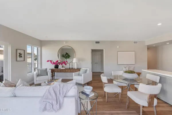 a living room with furniture and a potted plant
