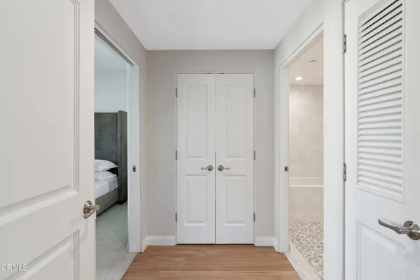 a bedroom with furniture and wooden floor