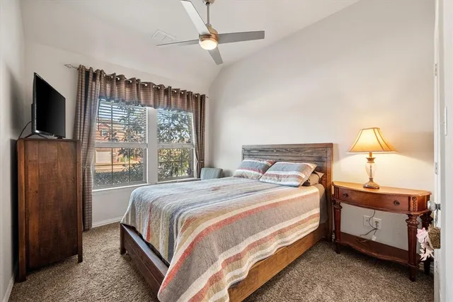 a bedroom with a bed and a flat tv screen