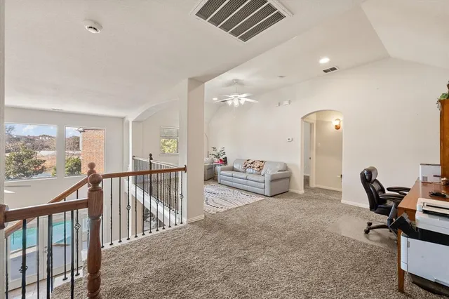 a view of a hallway with dining room and furniture