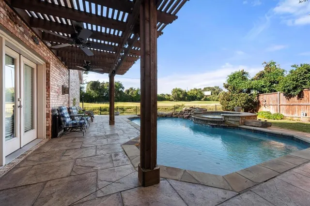 a view of swimming pool with outdoor seating