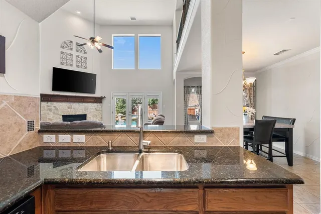 a kitchen with granite countertop a stove a sink and a granite counter tops