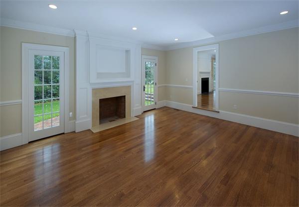 36 Whiting Road Wellesley, MA 02481 - Photo 4 of 8 an empty room with wooden floor fireplace and windows