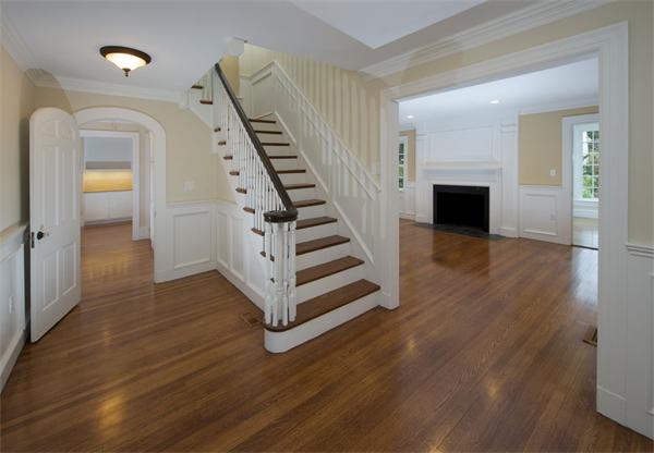 36 Whiting Road Wellesley, MA 02481 - Photo 5 of 8 a view of a hallway with wooden floor staircase and a living room