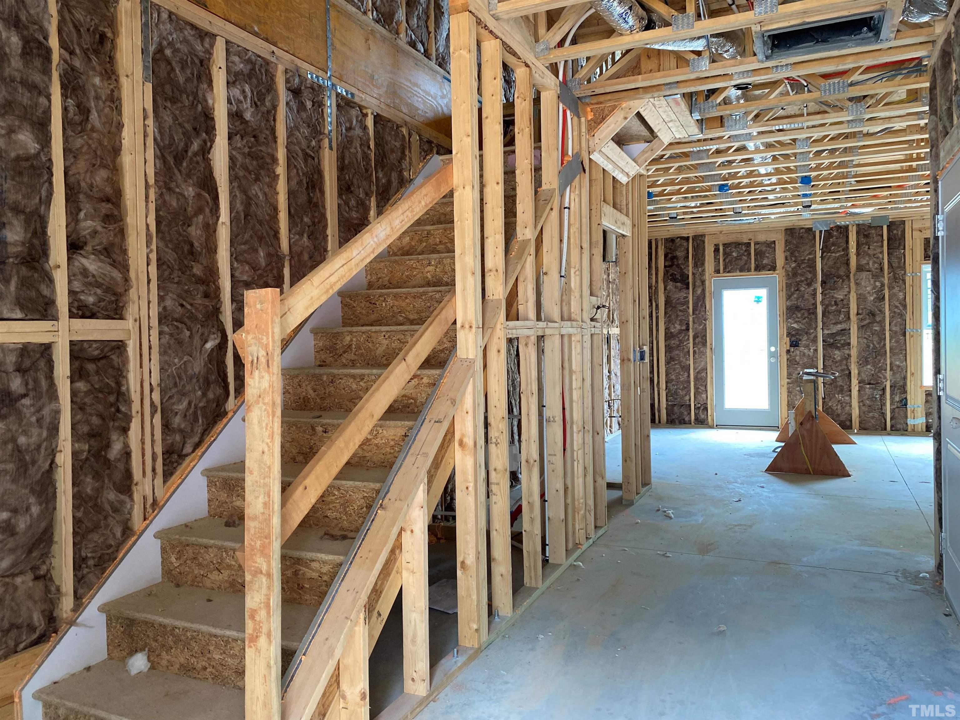 811 Star Rdg Drive Raleigh, NC 27610 - Photo 2 of 15 a view of staircase with lots of frames on wall and a window