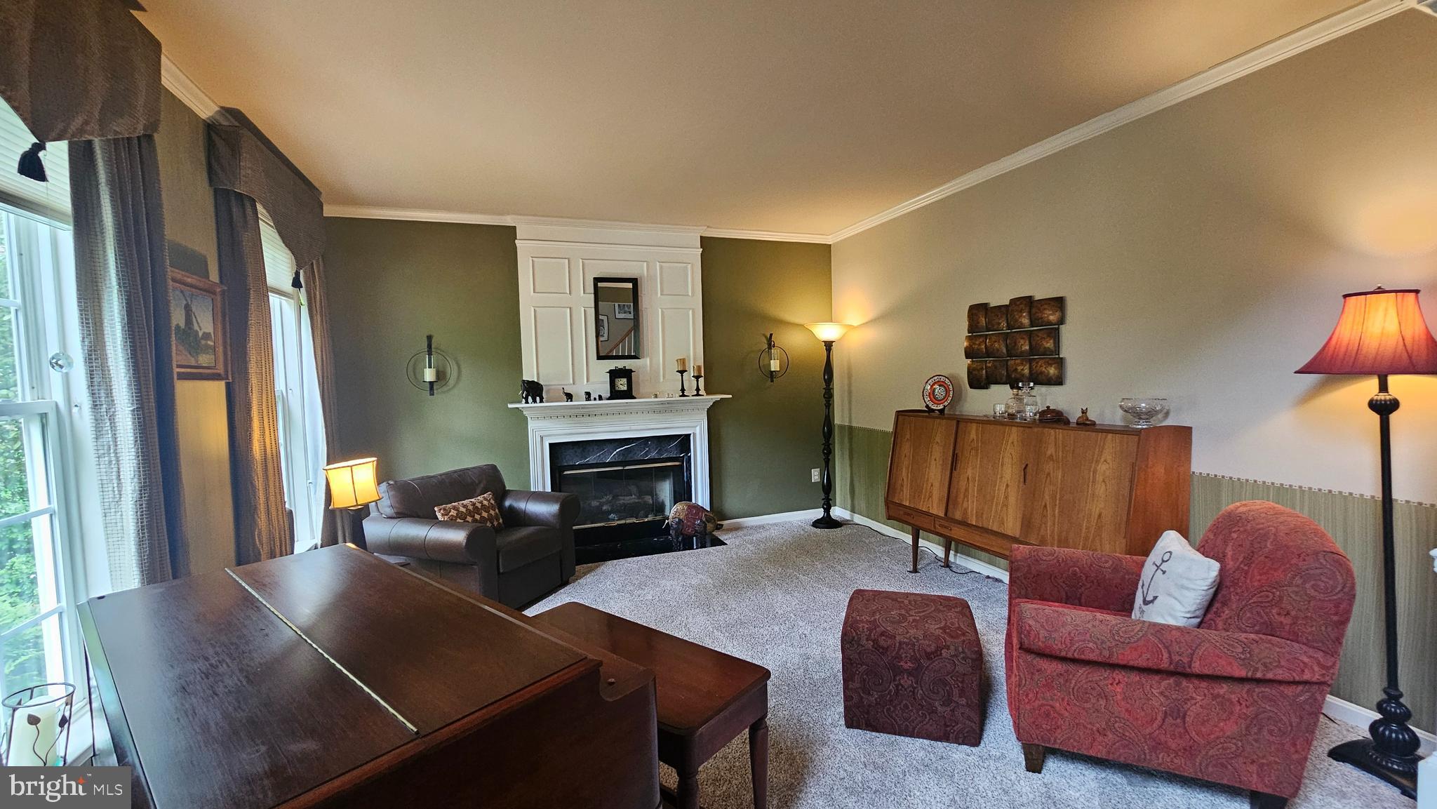 6107 Traceys Overlook Road Tracys Landing, MD 20779 - Photo 19 of 67 a living room with furniture rug and a fireplace