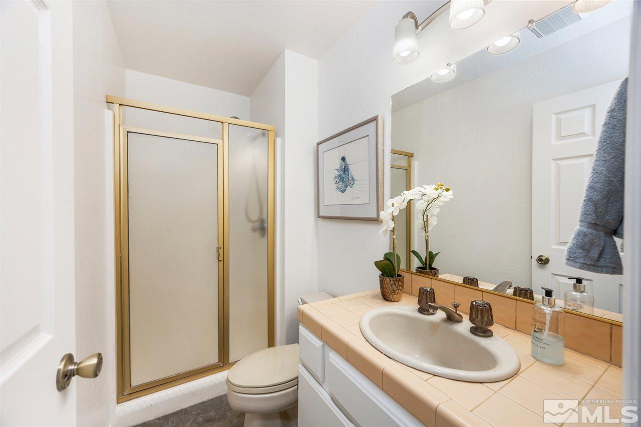 755a Bigler Circle, Unit B Stateline, NV 89449 - Photo 20 of 23 a bathroom with a sink a toilet and shower a mirror