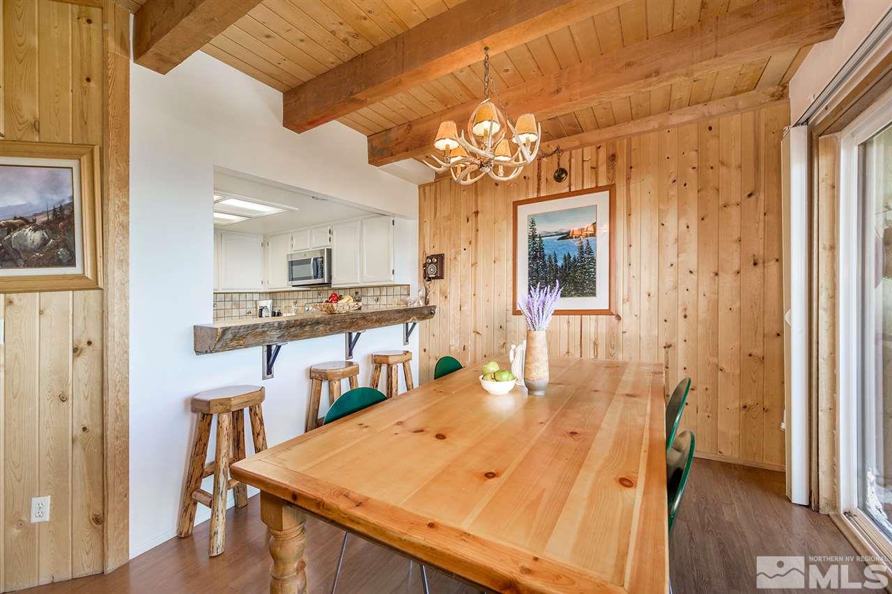 755a Bigler Circle, Unit B Stateline, NV 89449 - Photo 4 of 23 a view of a dining room with furniture and a chandelier
