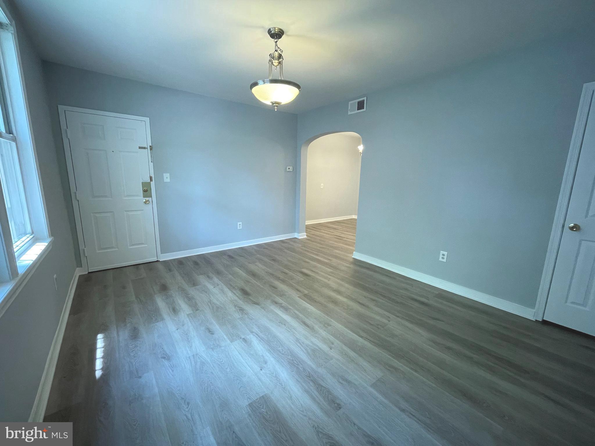 600 I Street Northeast, Unit 2 Washington, DC 20002 - Photo 2 of 19 an empty room with wooden floor and windows