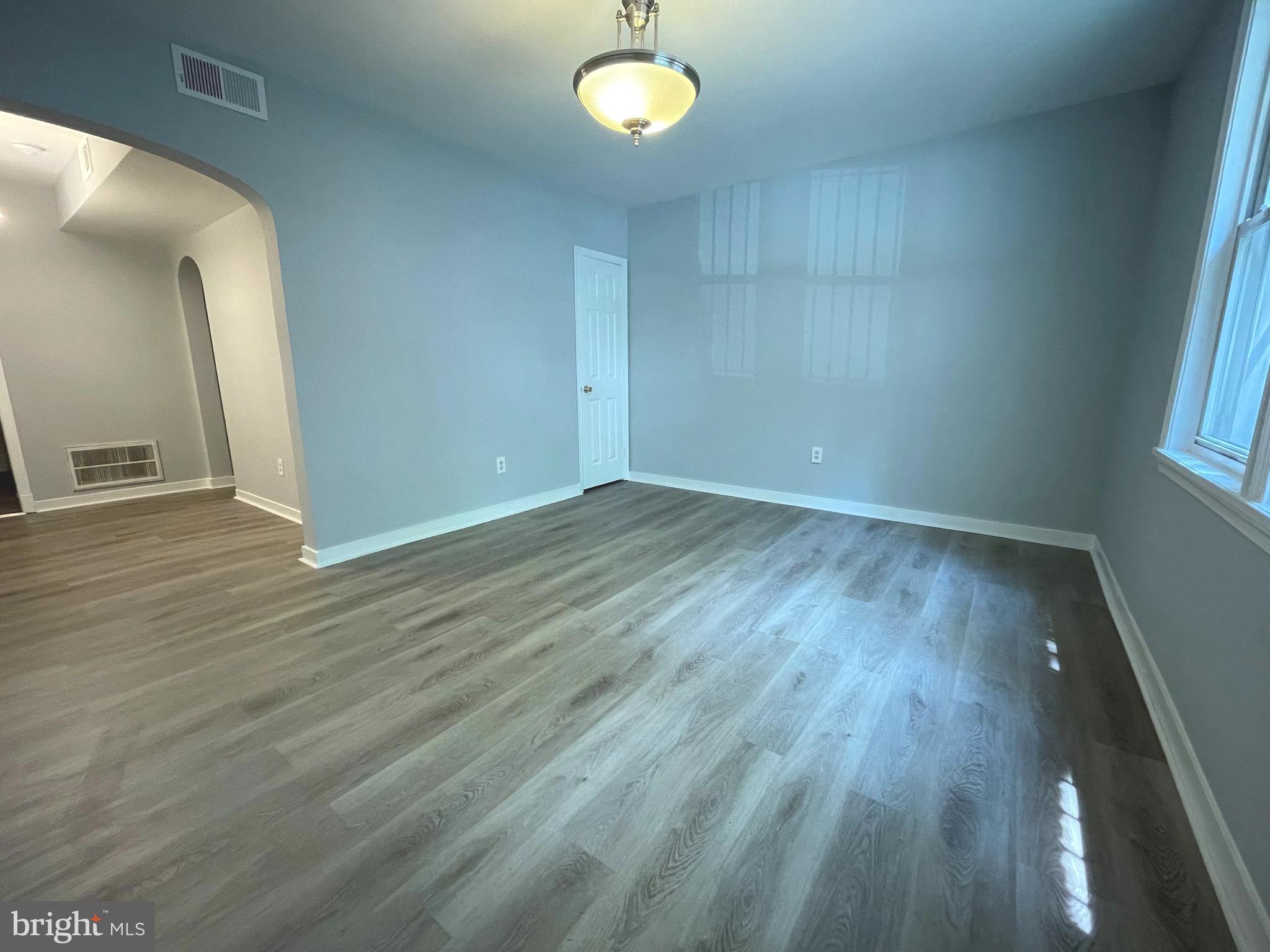 600 I Street Northeast, Unit 2 Washington, DC 20002 - Photo 3 of 19 a view of an empty room with wooden floor and a window