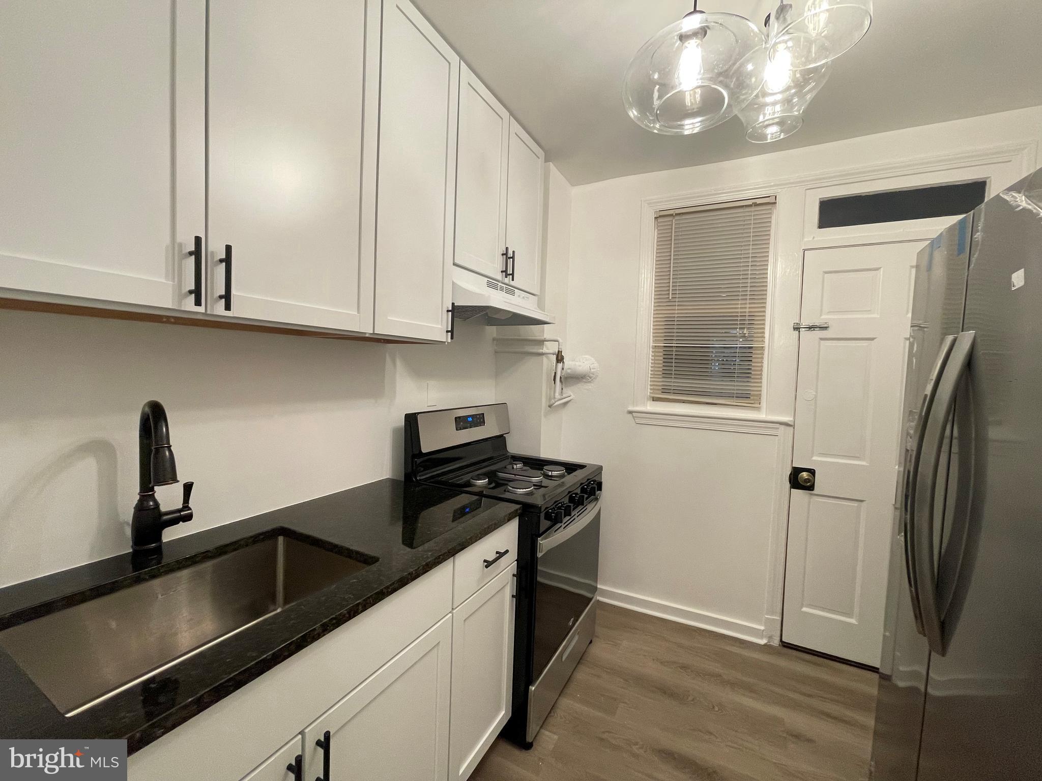 600 I Street Northeast, Unit 2 Washington, DC 20002 - Photo 5 of 19 a kitchen with stainless steel appliances granite countertop a sink a stove and a refrigerator