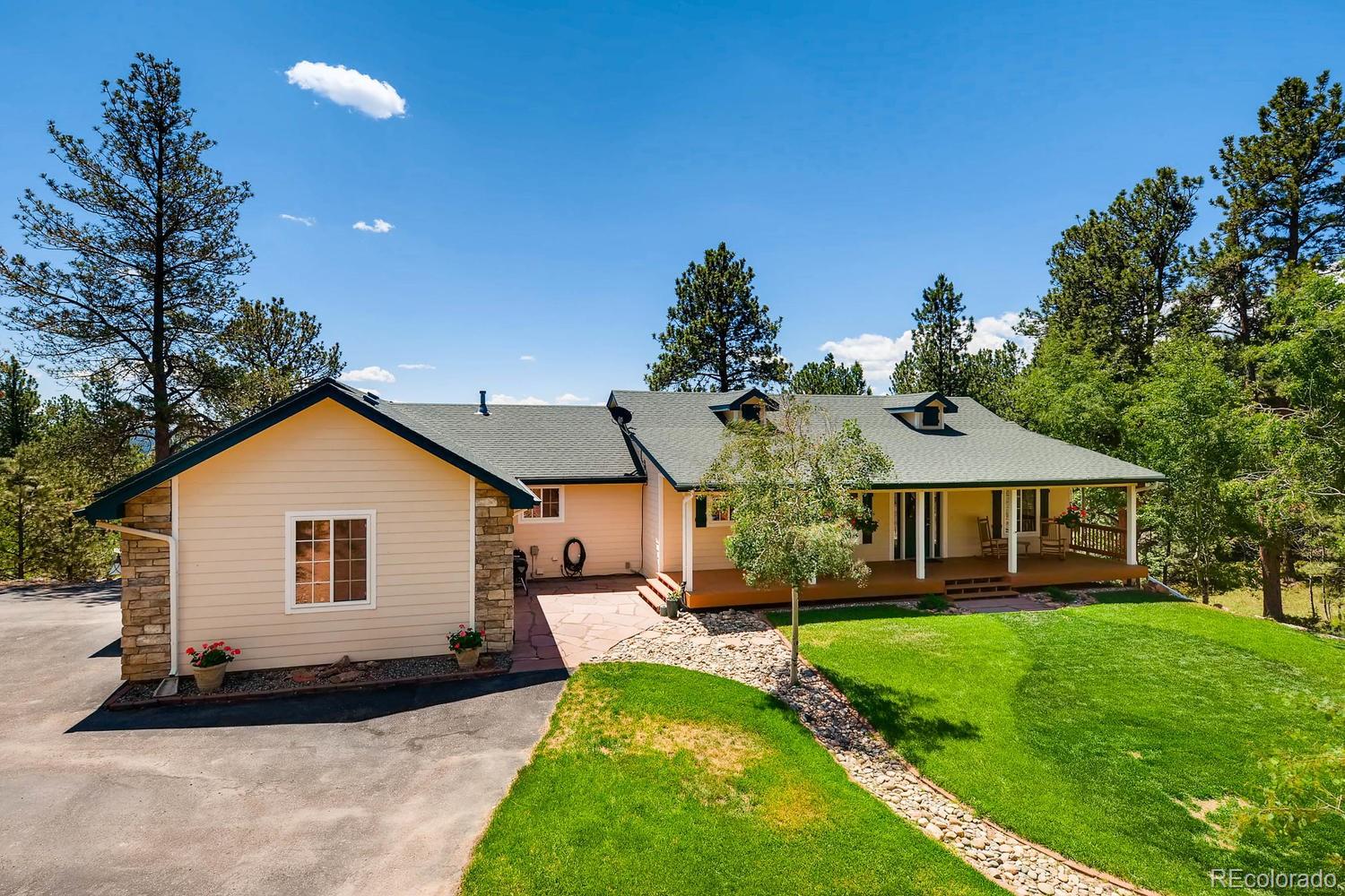 35681 Upper Aspen Lane Pine, CO 80470 - Photo 1 of 36 a front view of a house with a yard
