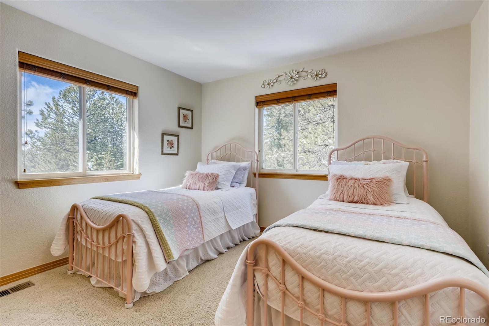 35681 Upper Aspen Lane Pine, CO 80470 - Photo 17 of 36 a bedroom with two beds and a large window