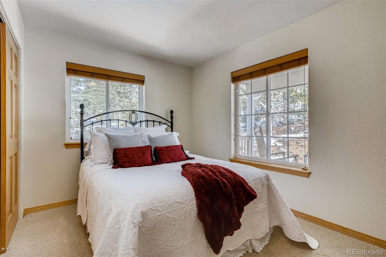 35681 Upper Aspen Lane Pine, CO 80470 - Photo 18 of 36 a bedroom with a bed and a large window