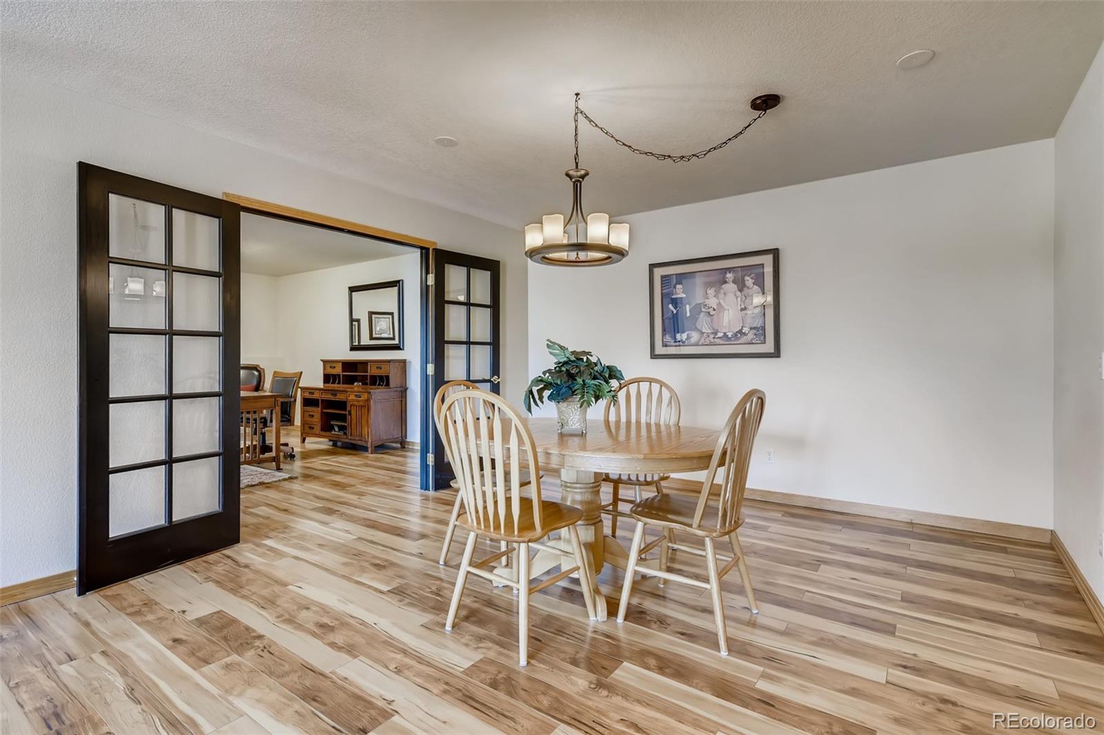 35681 Upper Aspen Lane Pine, CO 80470 - Photo 20 of 36 a view of a dining room with furniture and wooden floor