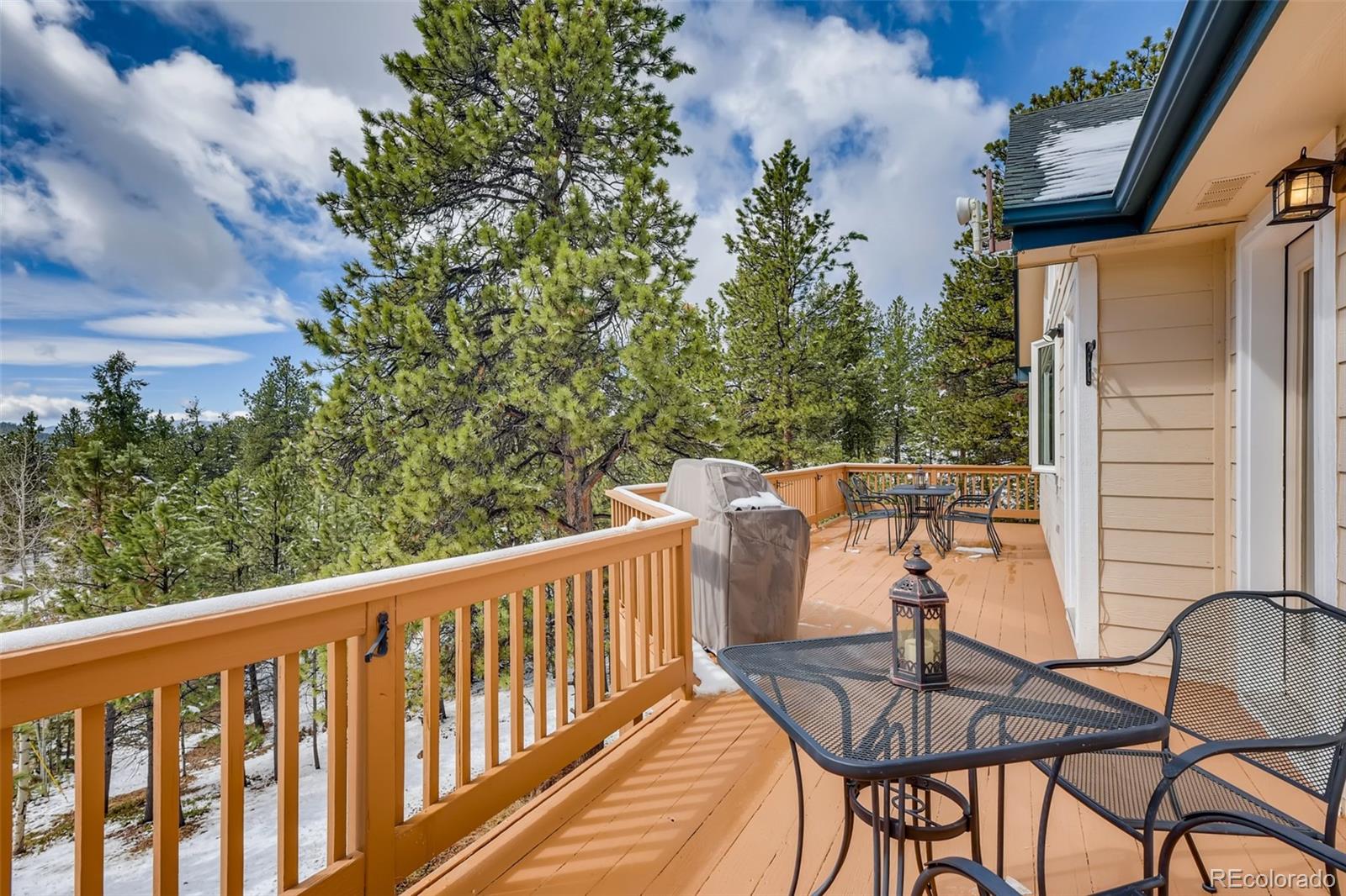 35681 Upper Aspen Lane Pine, CO 80470 - Photo 26 of 36 a balcony with table and chairs
