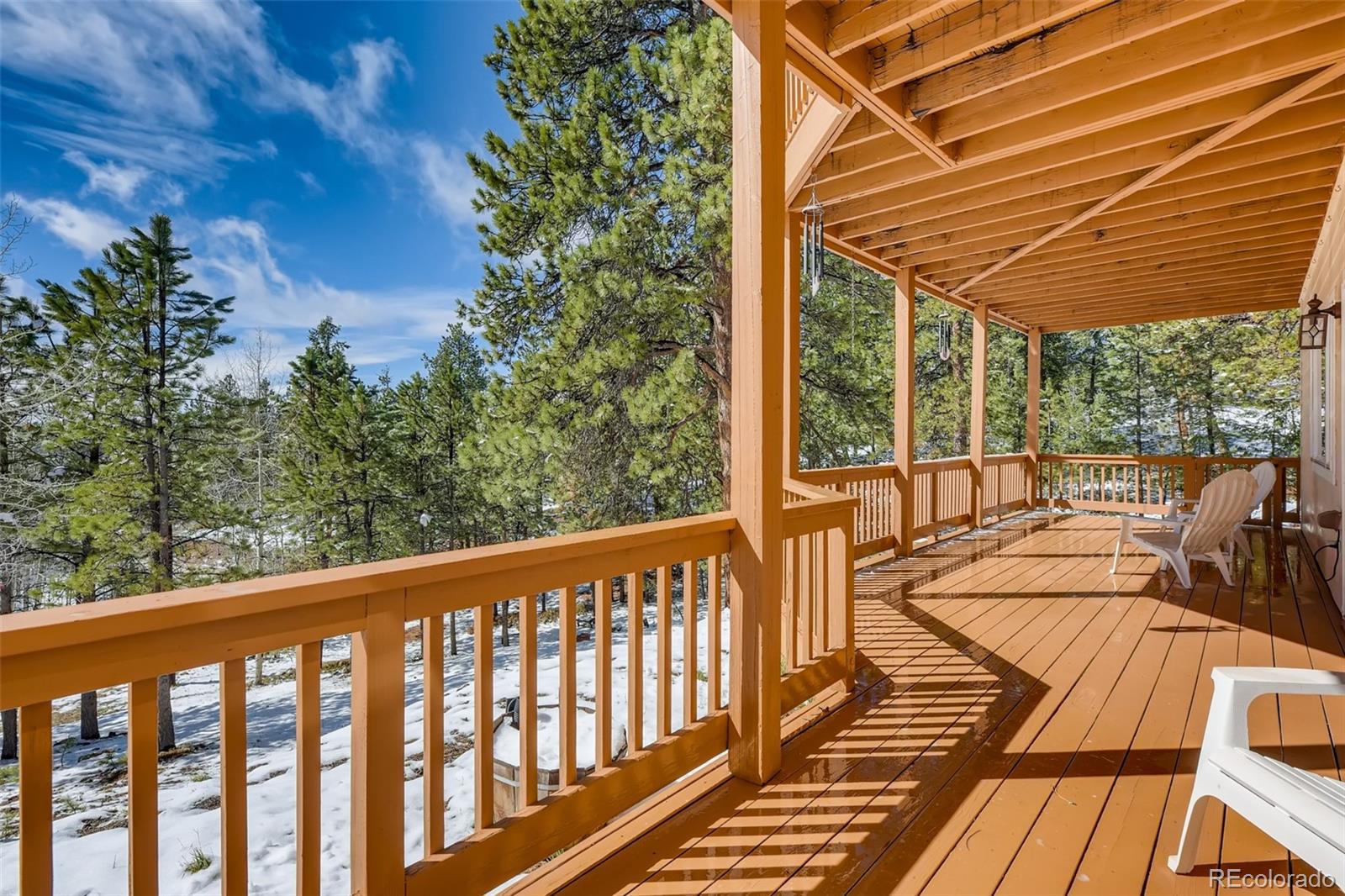 35681 Upper Aspen Lane Pine, CO 80470 - Photo 27 of 36 a view of a balcony with chairs and wooden floor