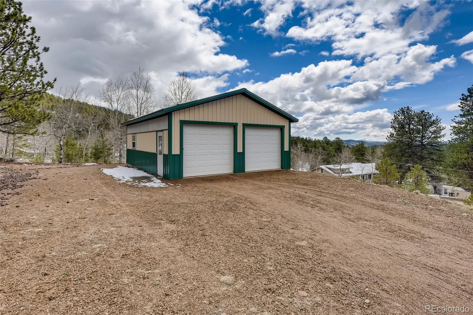 35681 Upper Aspen Lane Pine, CO 80470 - Photo 29 of 36 a view of a house with a patio
