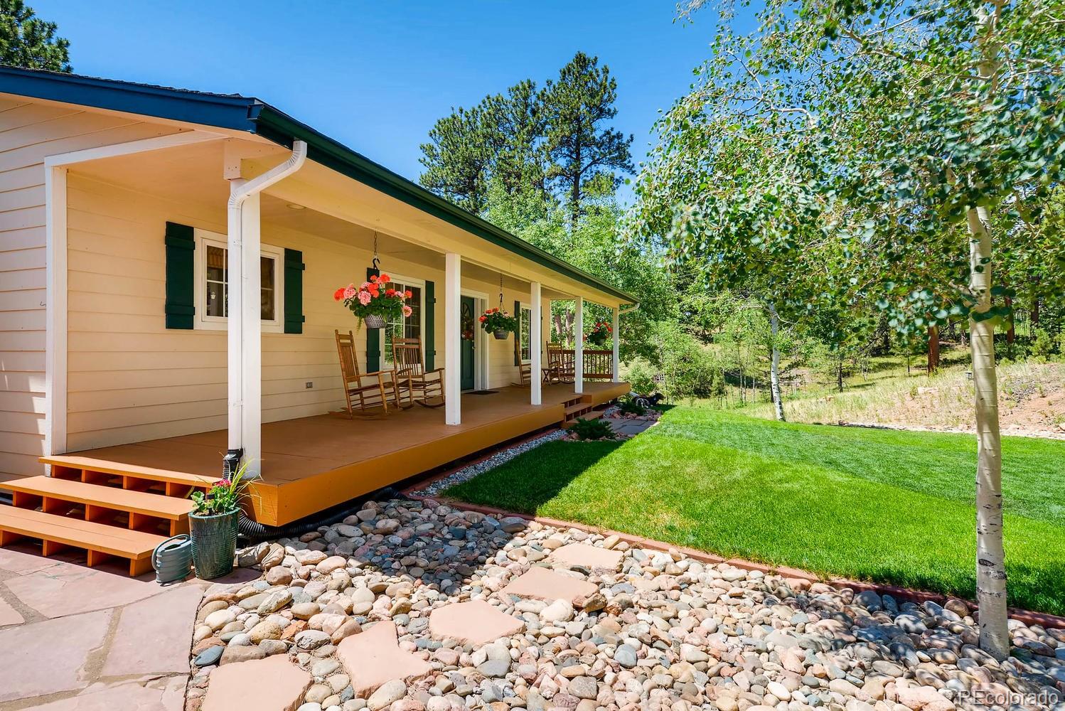 35681 Upper Aspen Lane Pine, CO 80470 - Photo 3 of 36 a front view of a house with garden