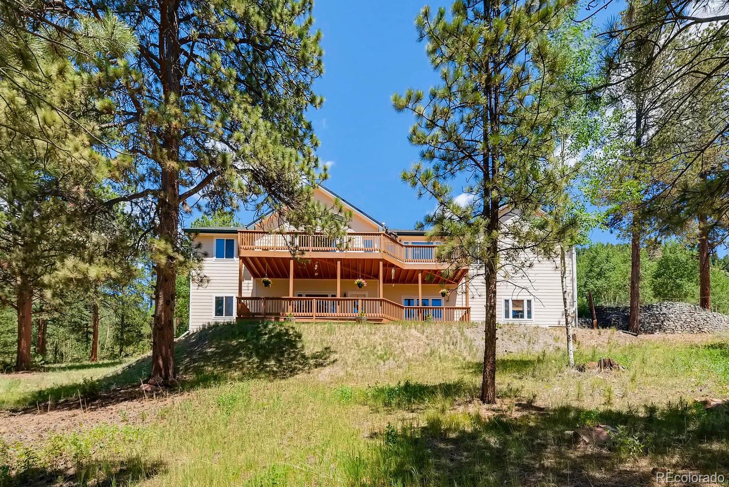 35681 Upper Aspen Lane Pine, CO 80470 - Photo 34 of 36 a view of a house with a yard covered by tree