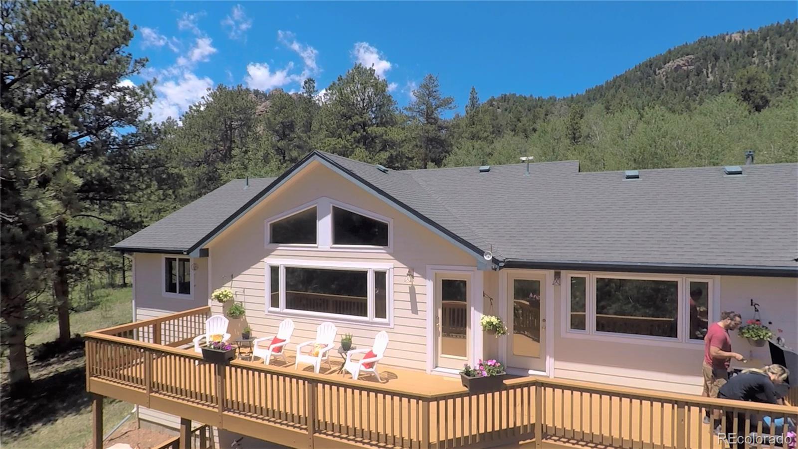 35681 Upper Aspen Lane Pine, CO 80470 - Photo 4 of 36 a front view of a house with a yard