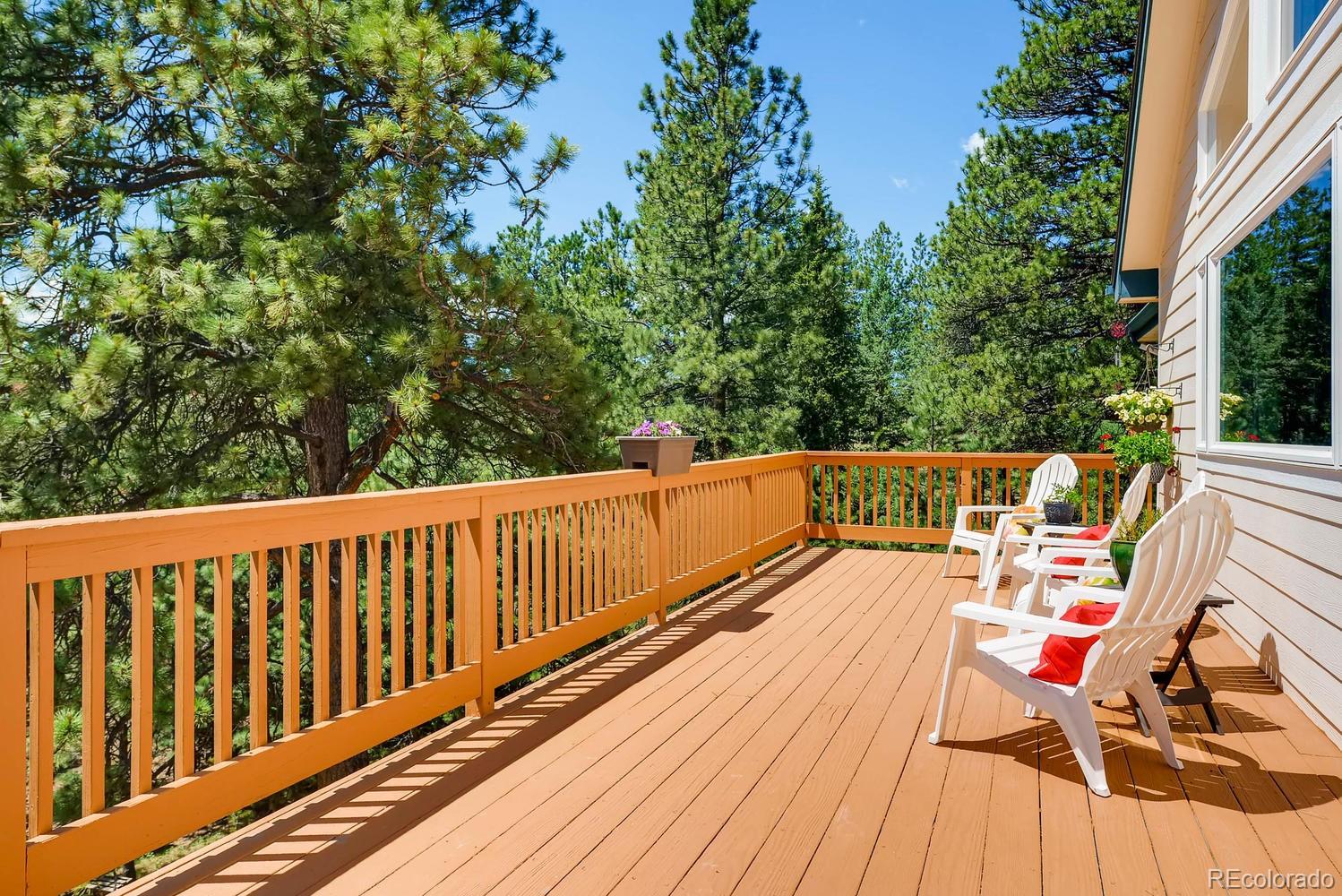 35681 Upper Aspen Lane Pine, CO 80470 - Photo 5 of 36 a balcony with wooden floor and outdoor space