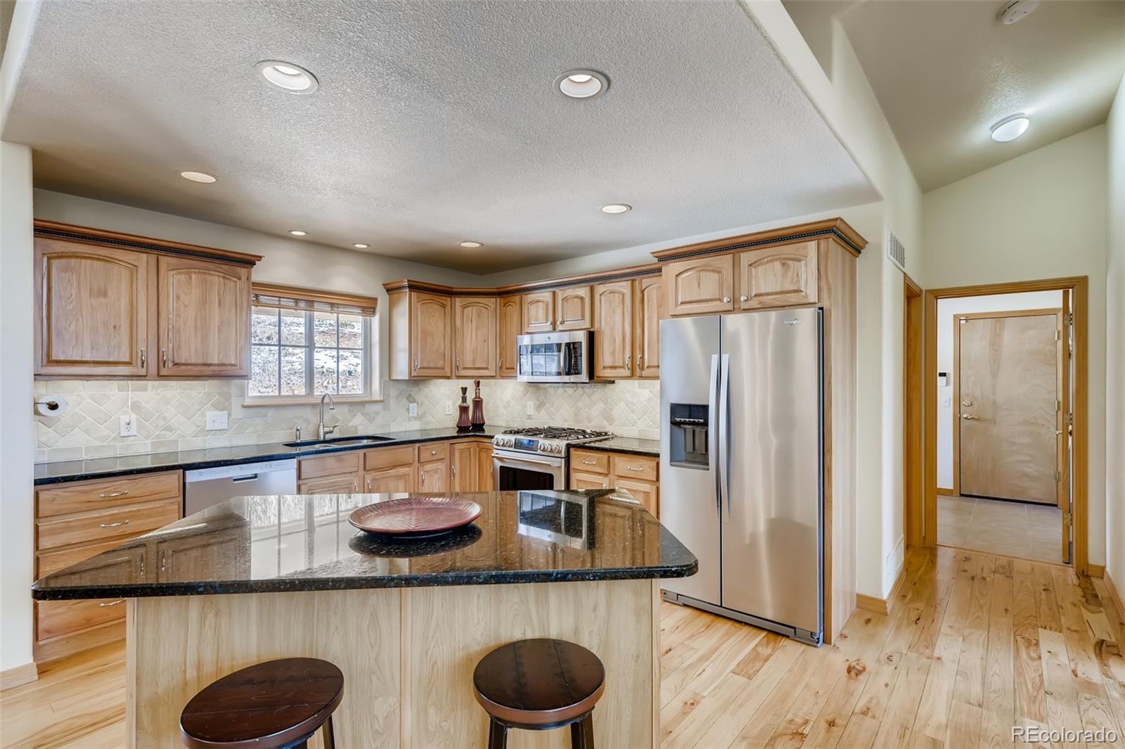 35681 Upper Aspen Lane Pine, CO 80470 - Photo 8 of 36 a kitchen with granite countertop cabinets and stainless steel appliances
