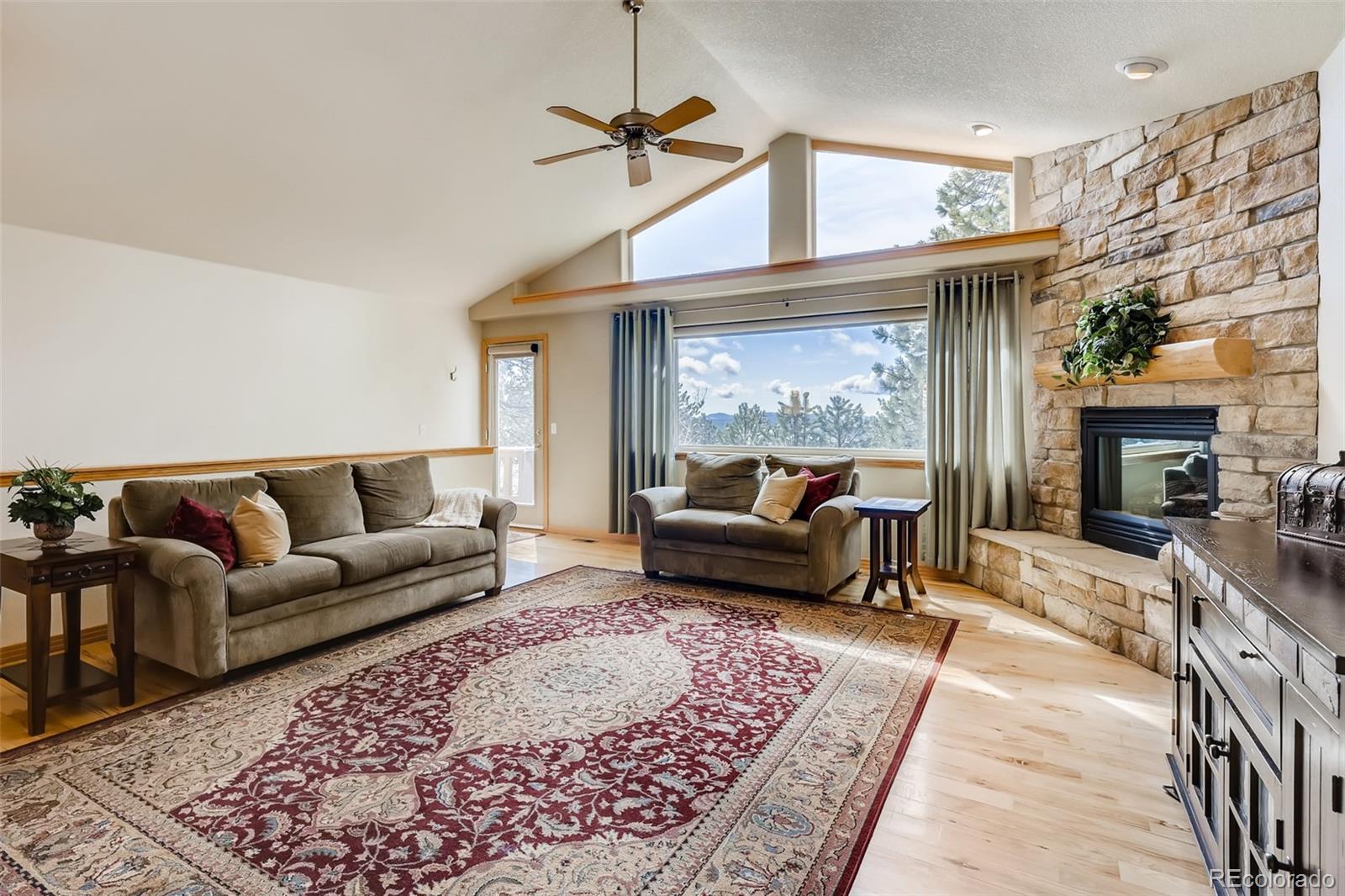 35681 Upper Aspen Lane Pine, CO 80470 - Photo 10 of 36 a living room with furniture and a fireplace