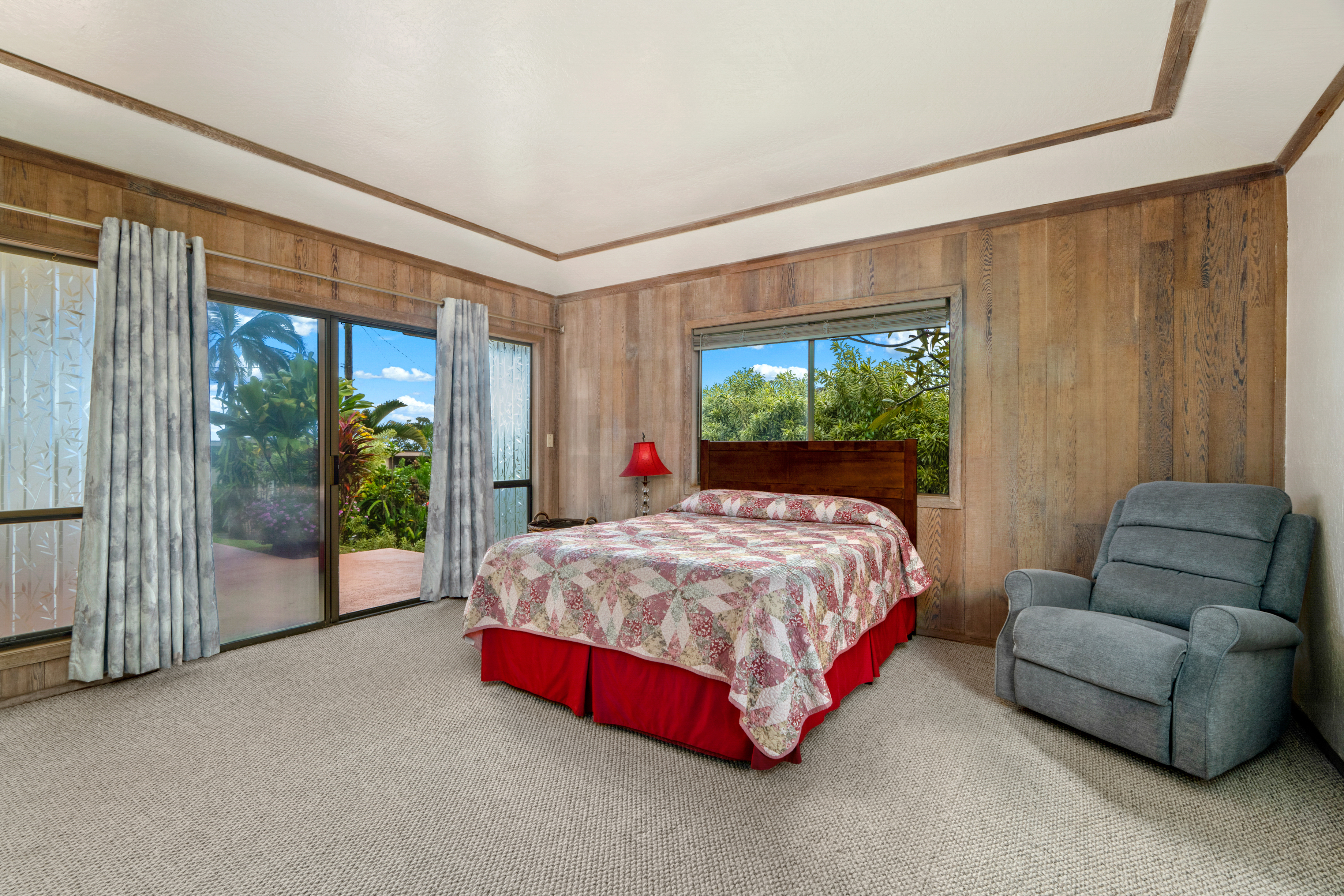 3587 Kaloke Street Kalaheo, HI 96741 - Photo 13 of 30 a spacious bedroom with a bed and a large window