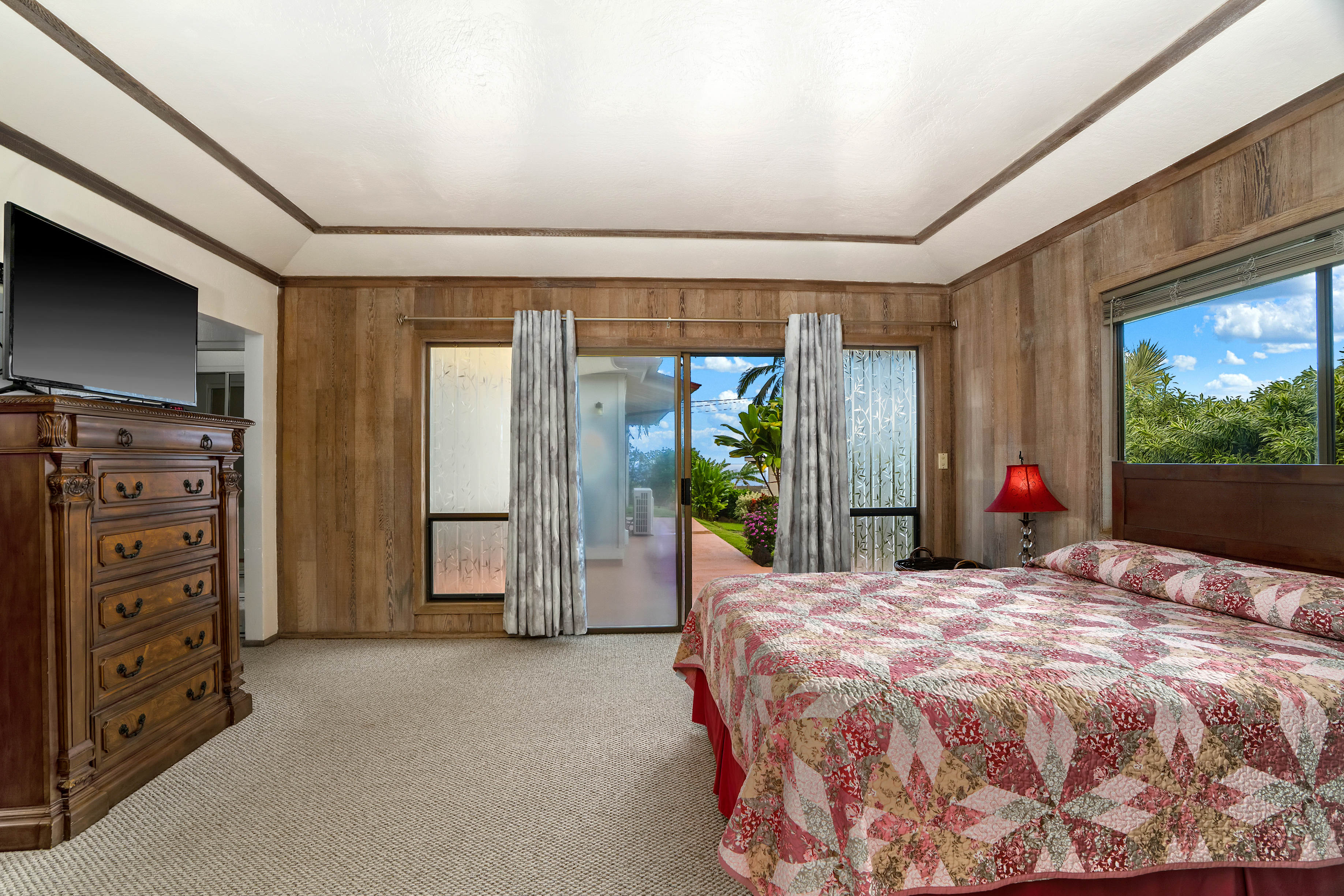 3587 Kaloke Street Kalaheo, HI 96741 - Photo 14 of 30 a bed sitting in a bedroom next to a window