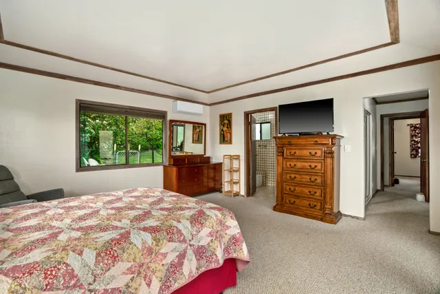 a bed sitting in a room next to a window