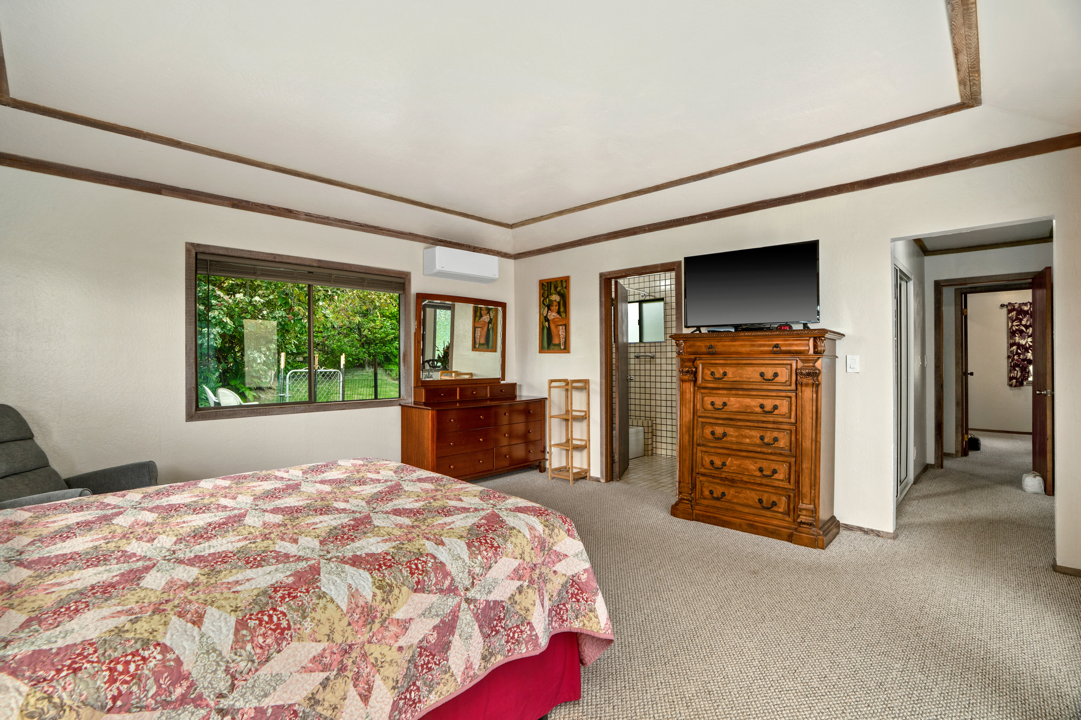 3587 Kaloke Street Kalaheo, HI 96741 - Photo 15 of 30 a spacious bedroom with a bed and a cabinets
