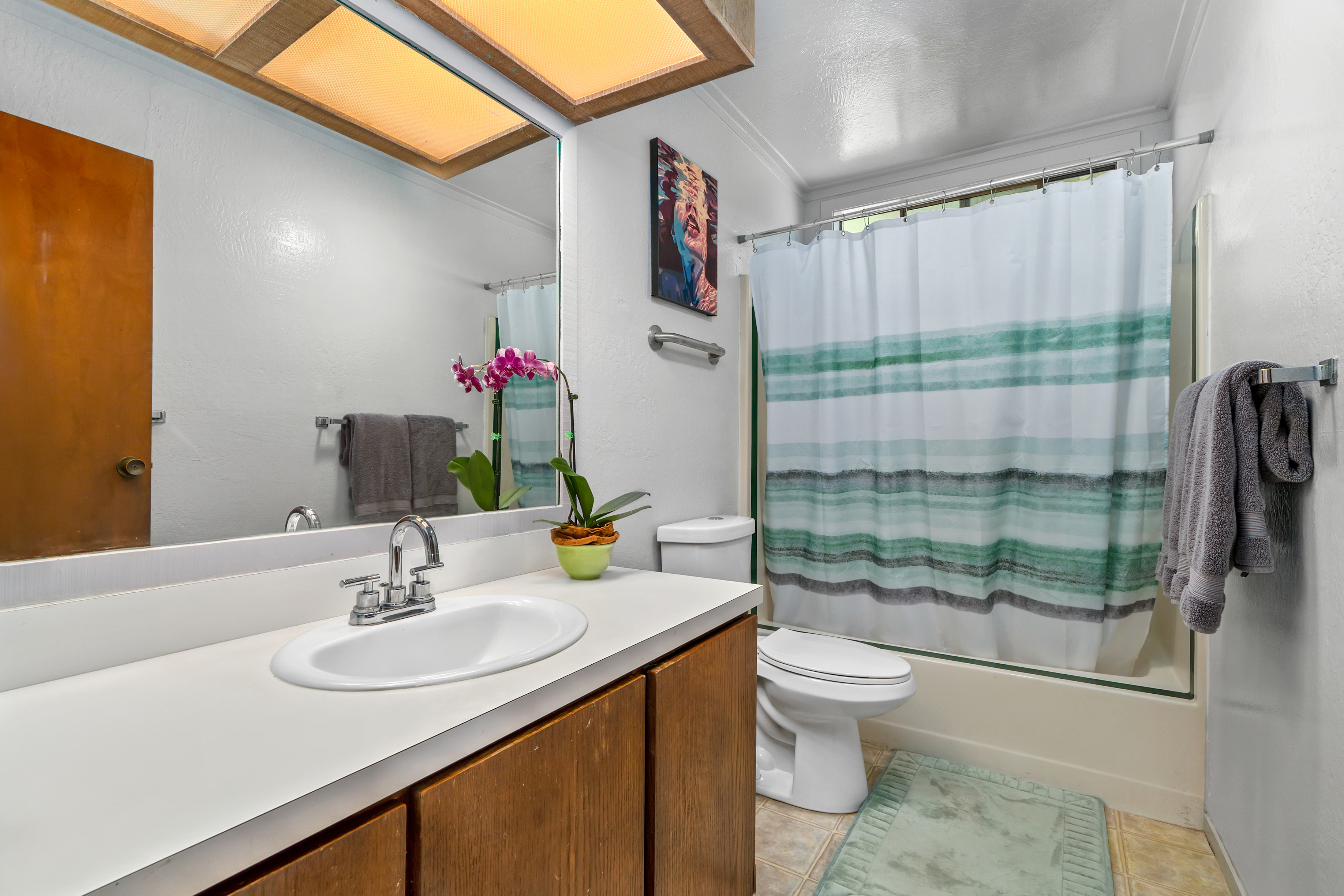 3587 Kaloke Street Kalaheo, HI 96741 - Photo 22 of 30 a bathroom with a sink toilet and shower