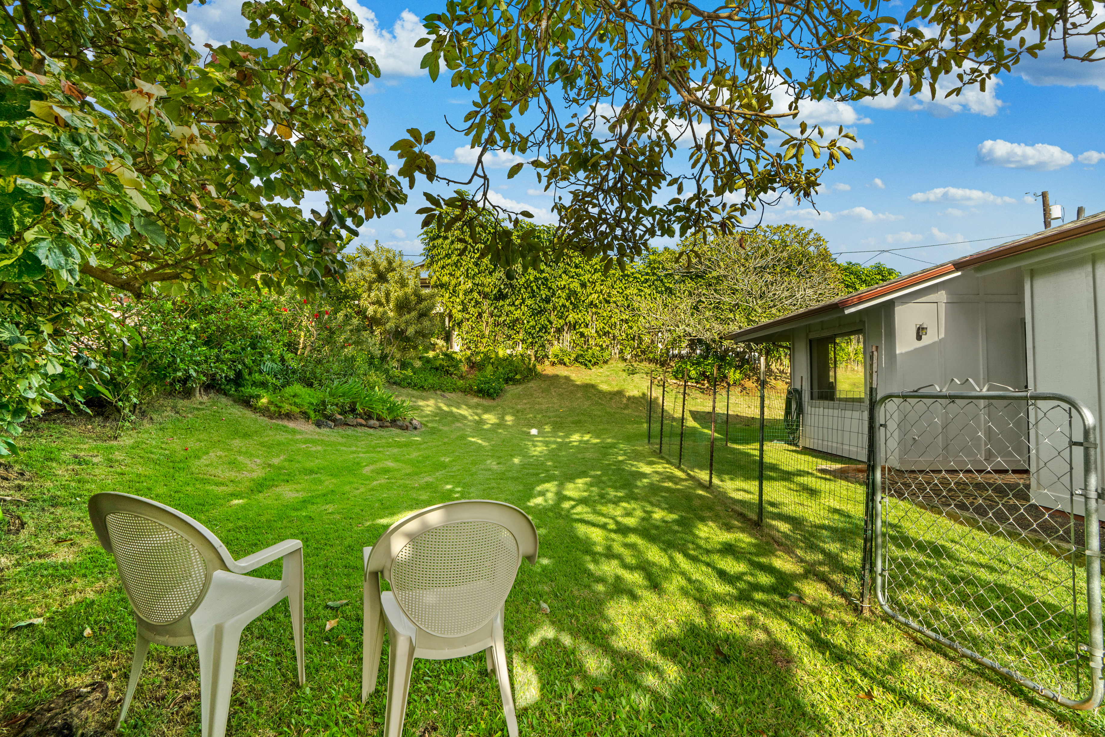 3587 Kaloke Street Kalaheo, HI 96741 - Photo 24 of 30 a backyard of a house with table and chairs