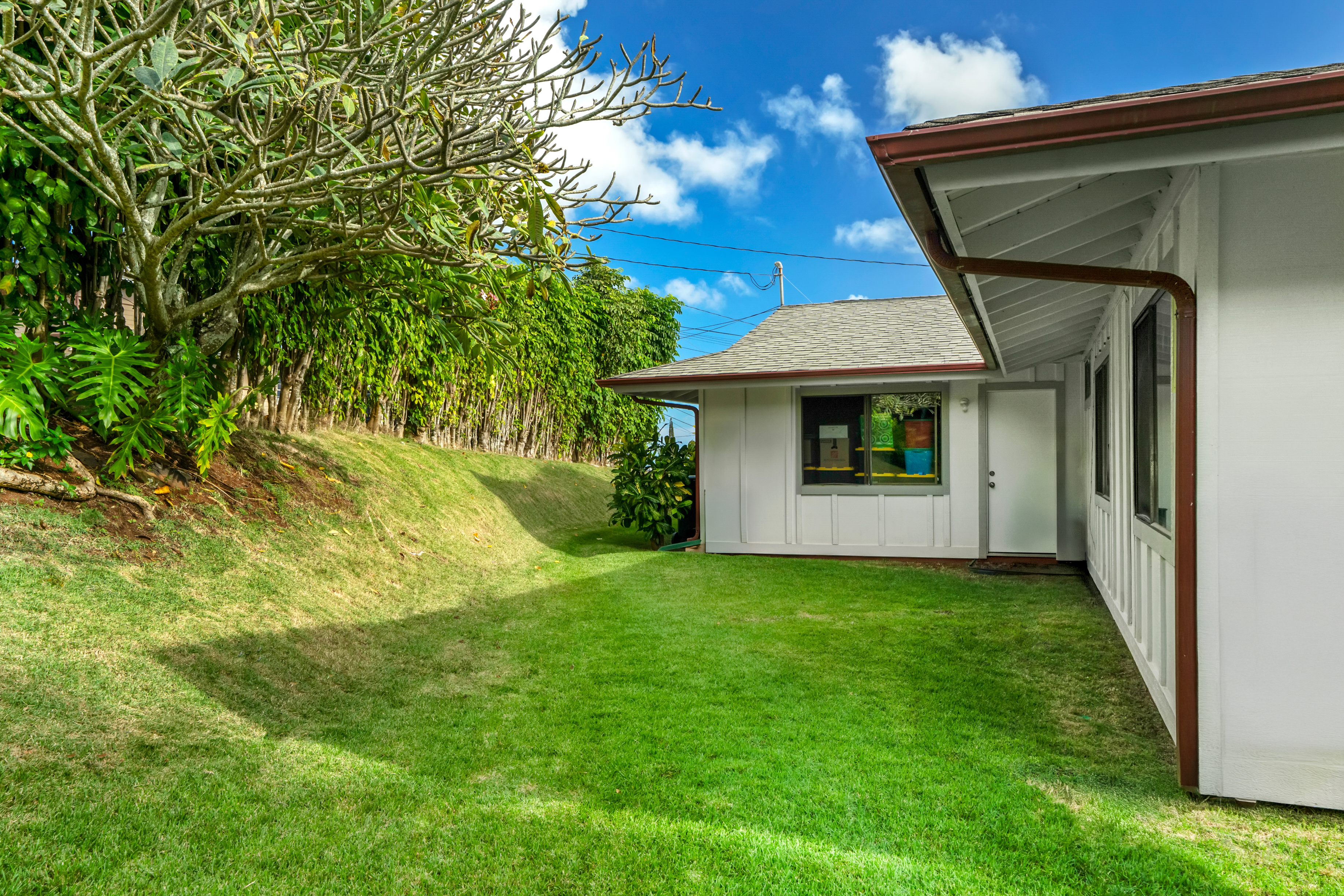 3587 Kaloke Street Kalaheo, HI 96741 - Photo 25 of 30 a view of a white house with a big yard