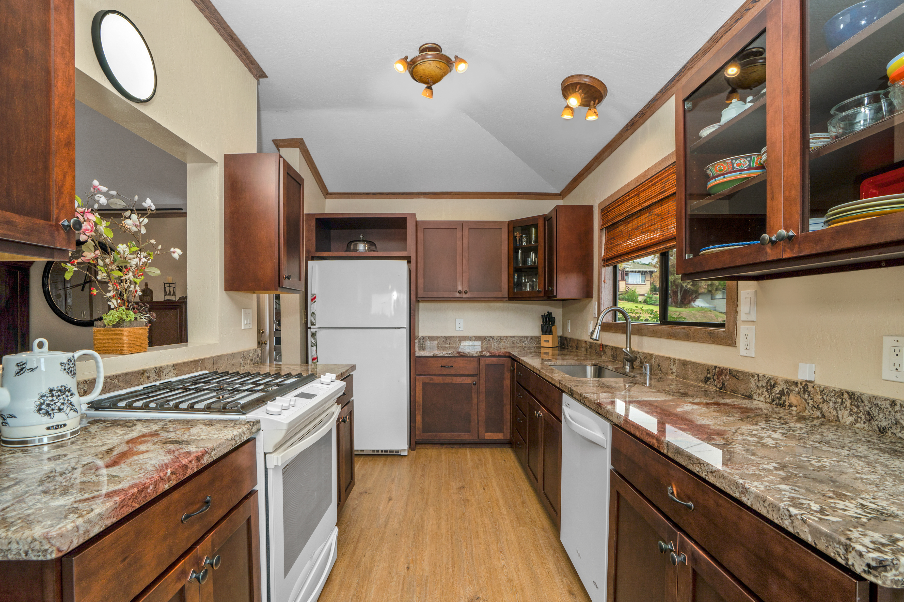 3587 Kaloke Street Kalaheo, HI 96741 - Photo 6 of 30 a kitchen with stainless steel appliances granite countertop a stove and a sink