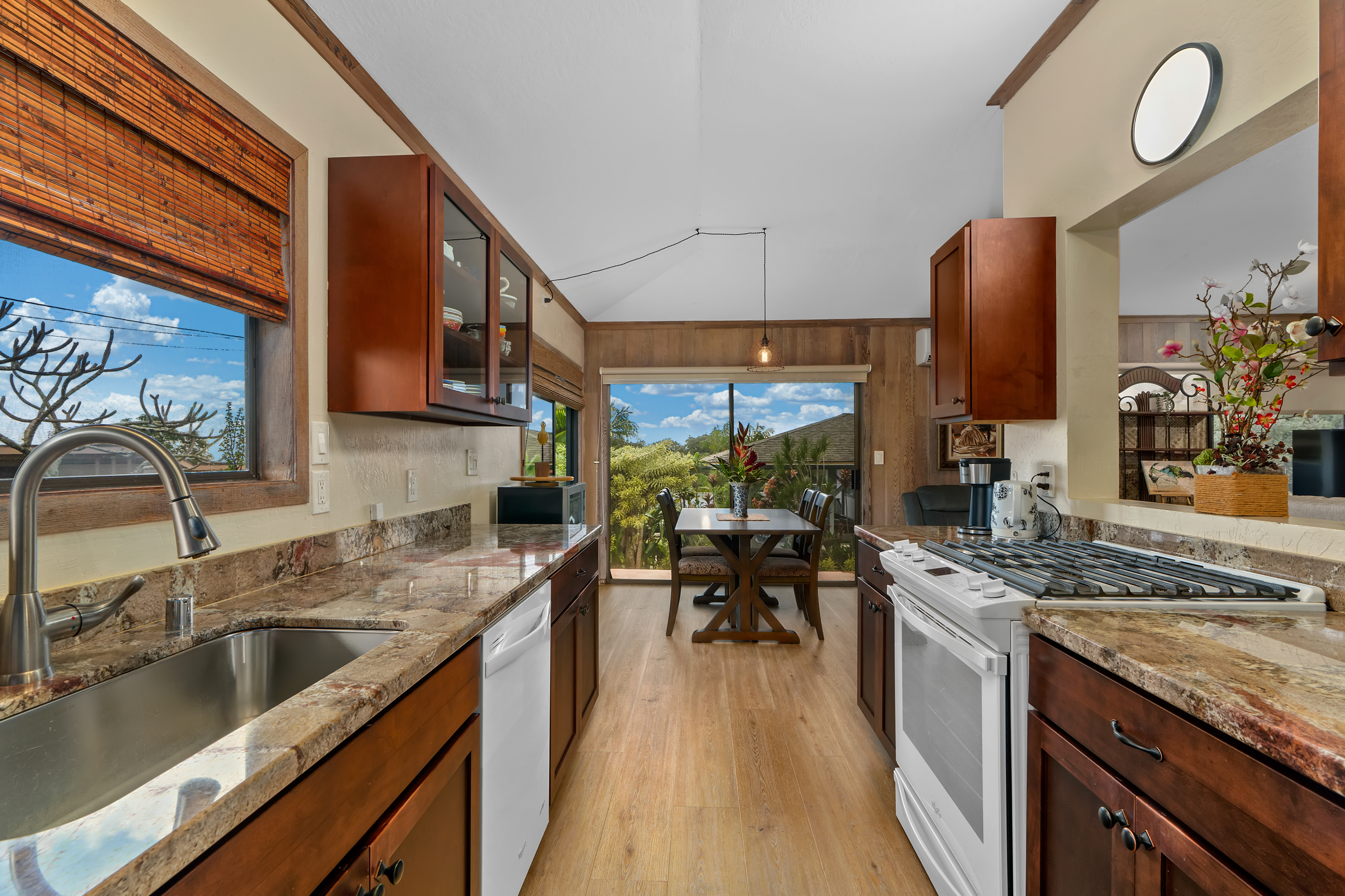 3587 Kaloke Street Kalaheo, HI 96741 - Photo 7 of 30 a kitchen with stainless steel appliances granite countertop a sink stove and cabinets