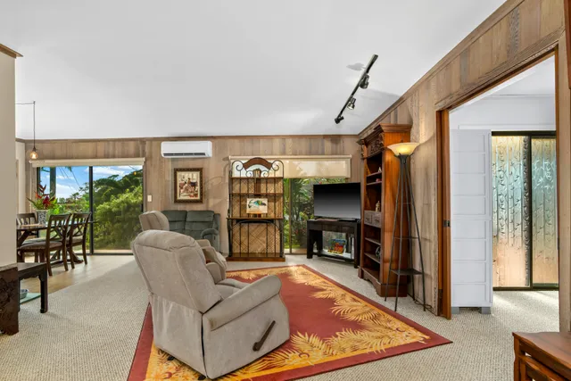 a living room with furniture a window and gym equipment