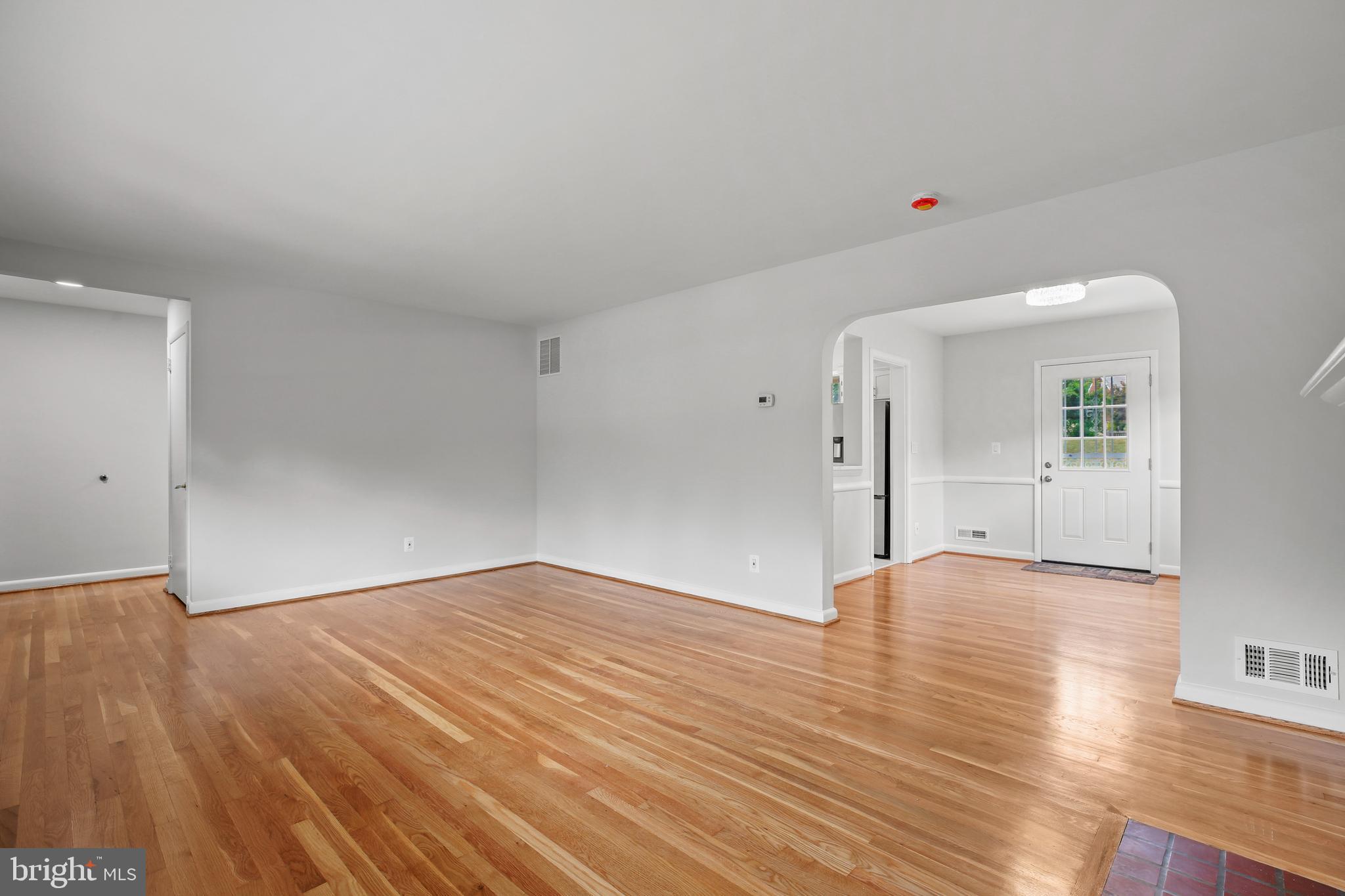 1445 Northgate Road Northwest Washington, DC 20012 - Photo 5 of 20 a view of an empty room with wooden floor and a window