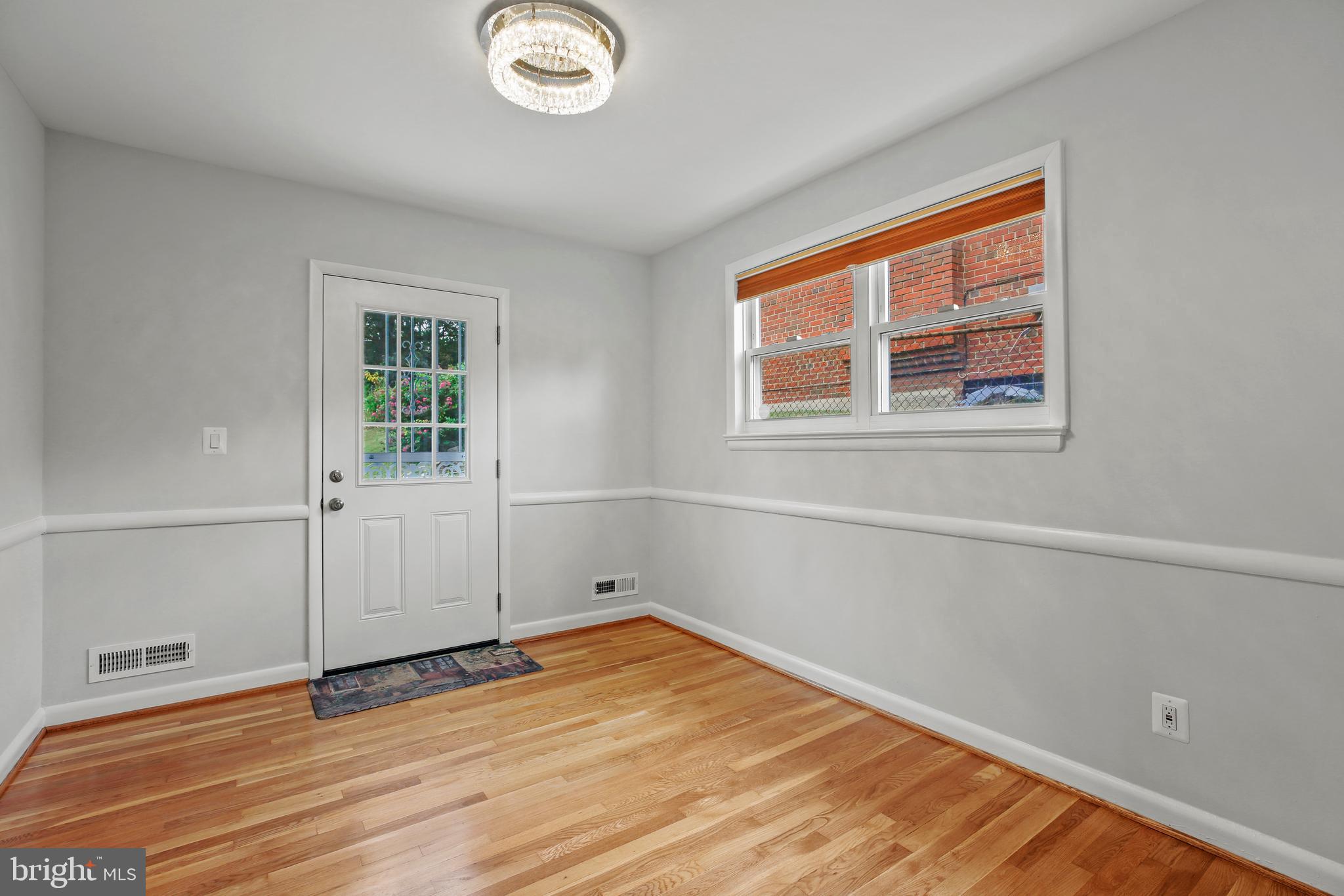 1445 Northgate Road Northwest Washington, DC 20012 - Photo 6 of 20 an empty room with wooden floor and windows