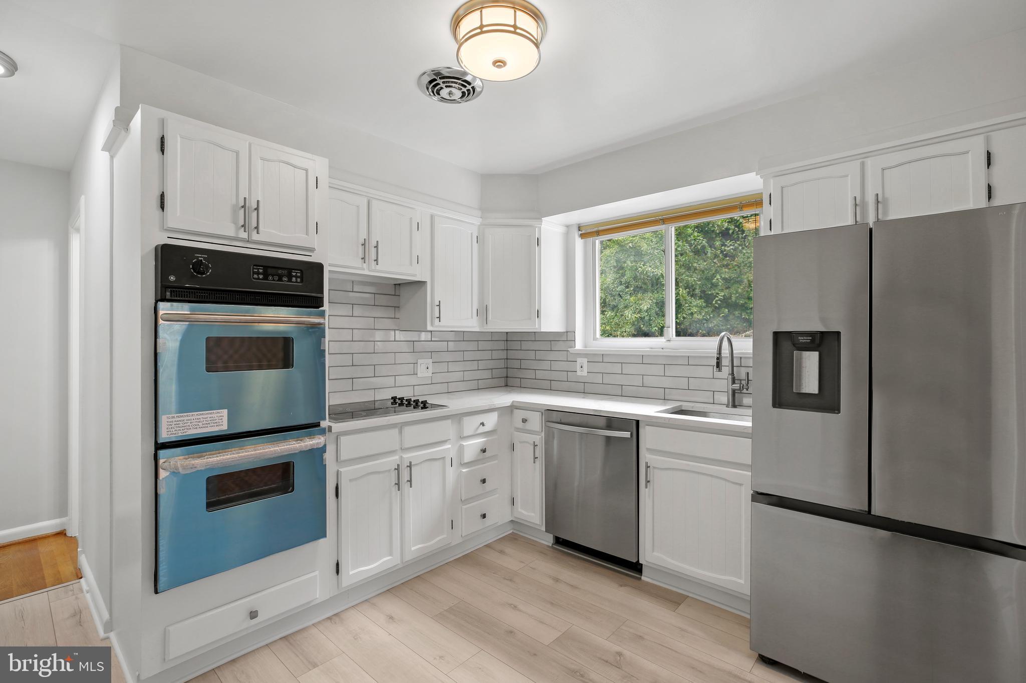 1445 Northgate Road Northwest Washington, DC 20012 - Photo 9 of 20 a kitchen with a refrigerator sink and microwave