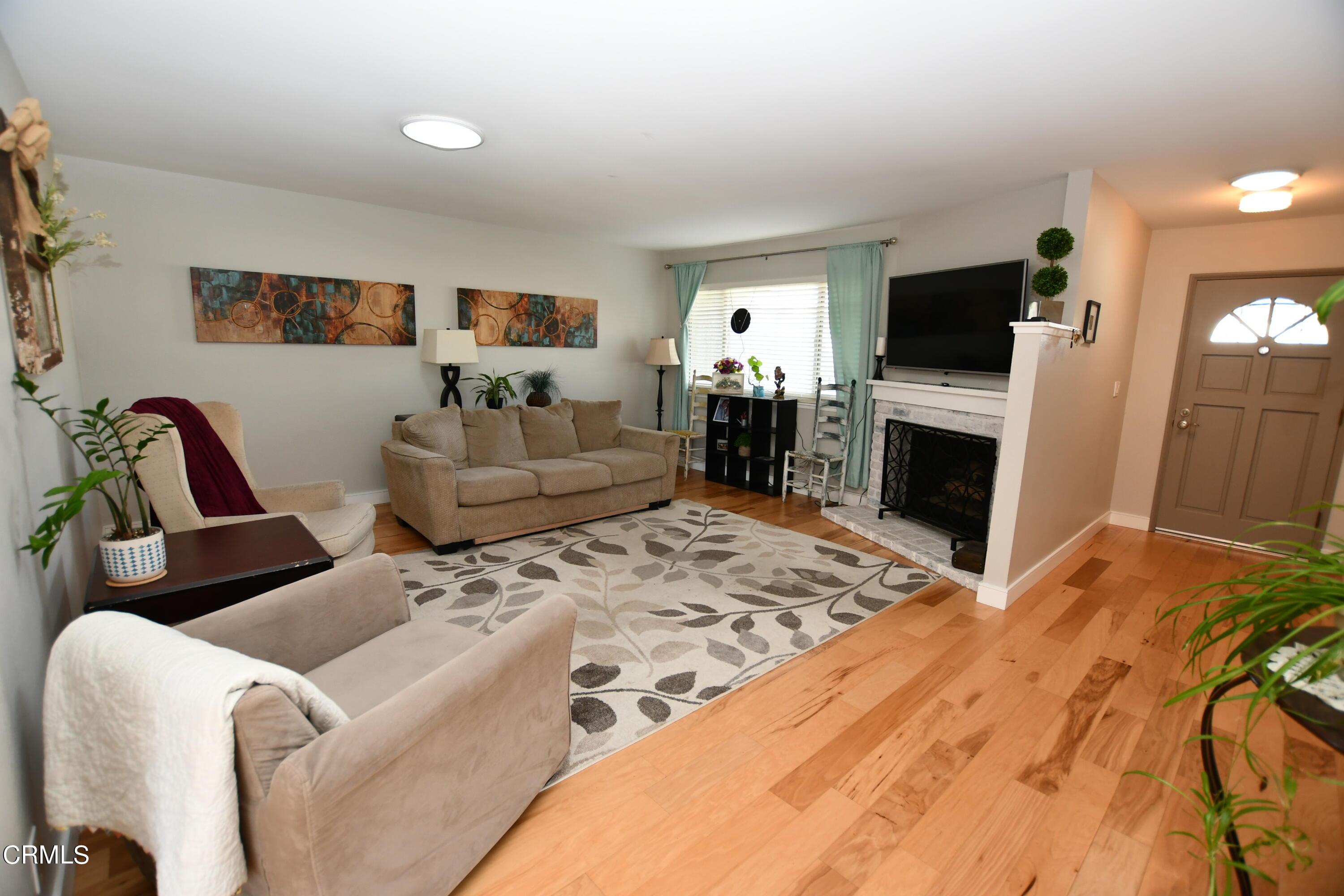 1711 Masthead Drive Oxnard, CA 93035 - Photo 2 of 18 a living room with furniture a flat screen tv and a refrigerator