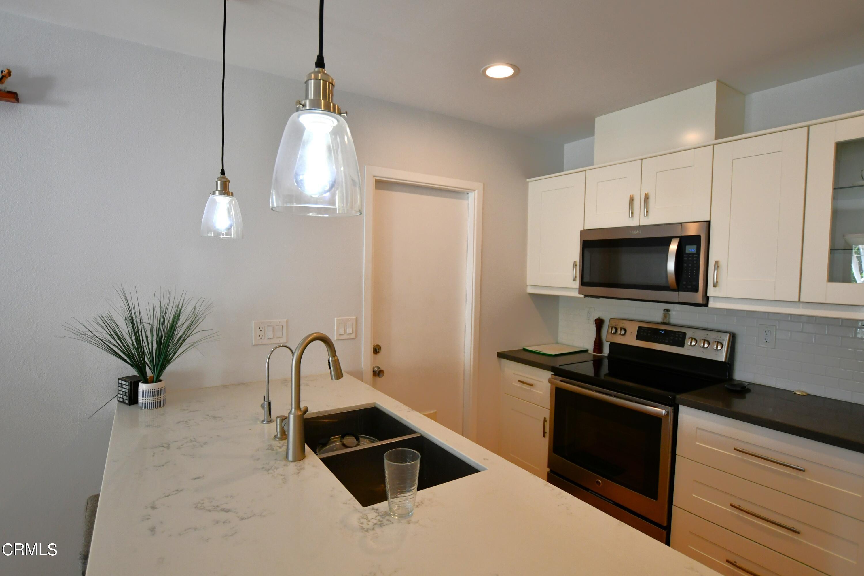1711 Masthead Drive Oxnard, CA 93035 - Photo 6 of 18 a kitchen with a sink a counter and cabinets