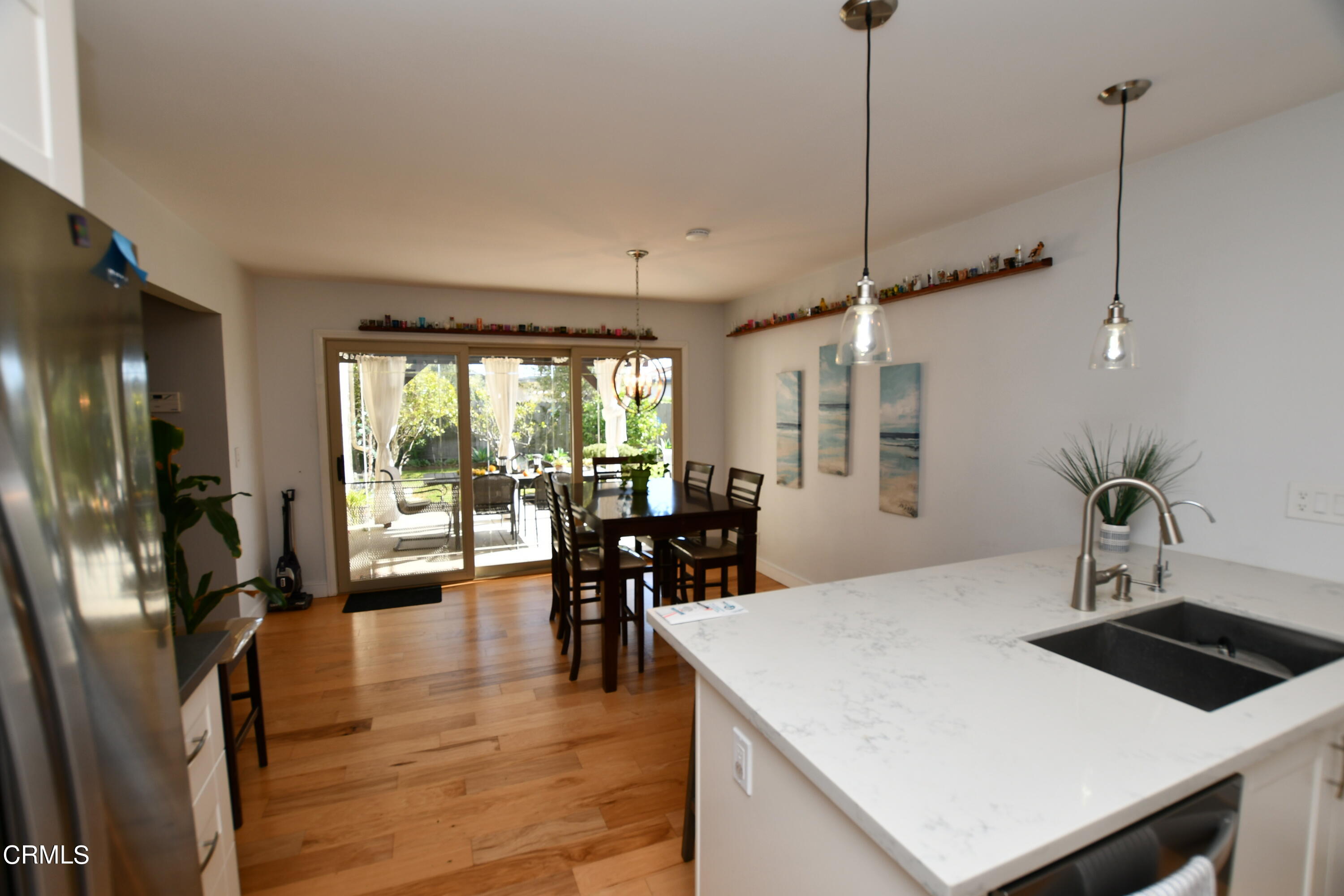 1711 Masthead Drive Oxnard, CA 93035 - Photo 7 of 18 a view of a dining room with furniture window and wooden floor