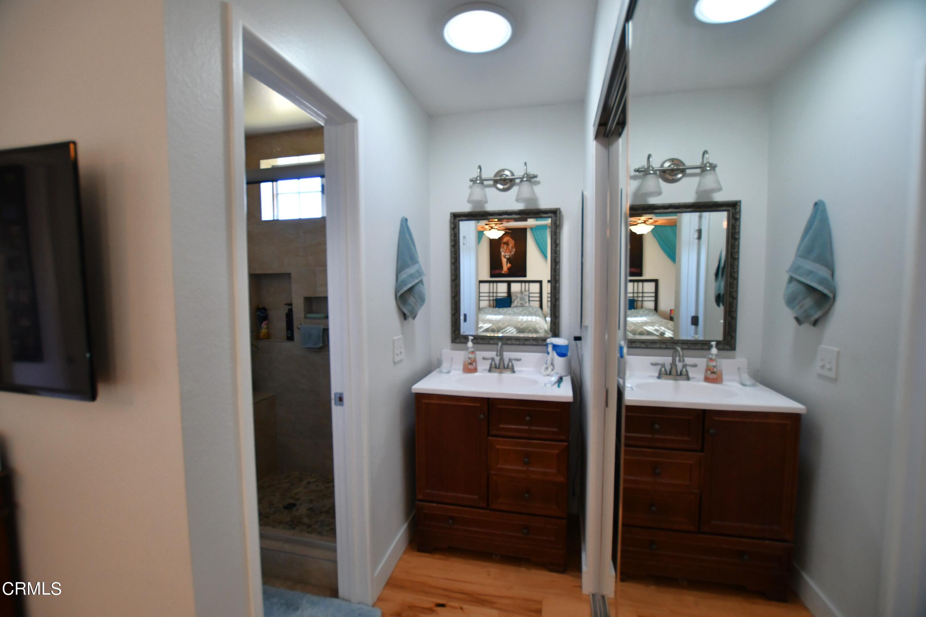 1711 Masthead Drive Oxnard, CA 93035 - Photo 10 of 18 a en suite bathroom with a sink and mirror