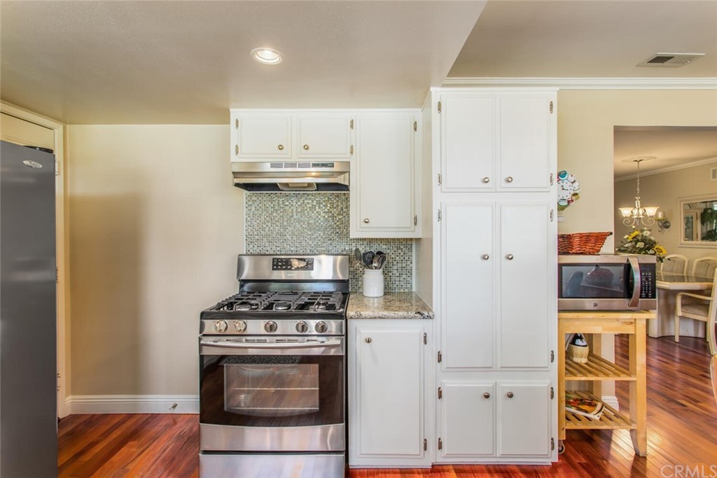 602 Juniper Court Redlands, CA 92374 - Photo 13 of 38 a kitchen with stainless steel appliances a stove and a refrigerator