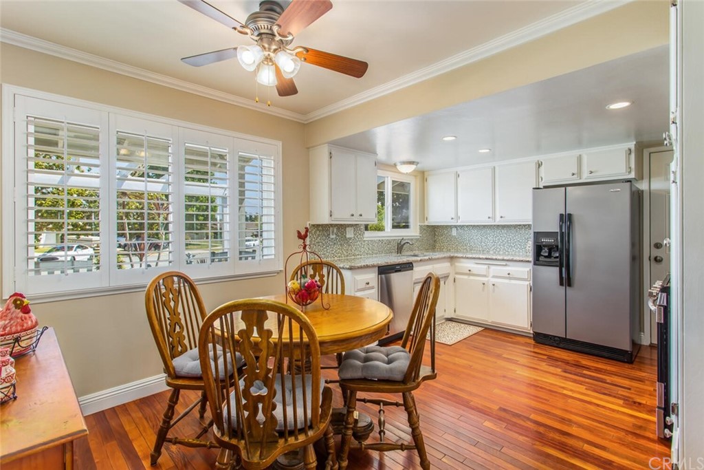 602 Juniper Court Redlands, CA 92374 - Photo 7 of 38 a dining room with stainless steel appliances granite countertop a dining table chairs and a refrigerator
