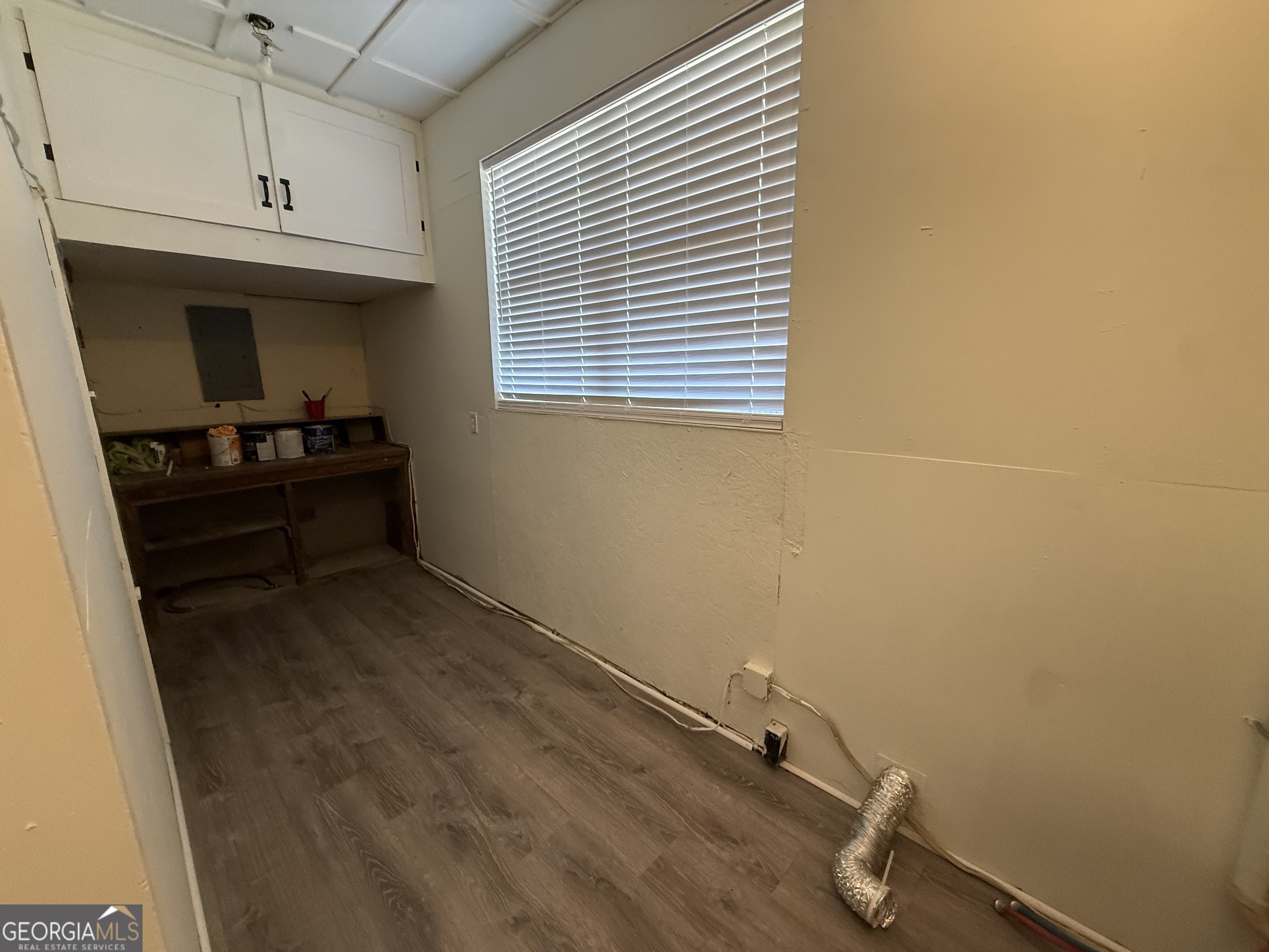 108 Plum Street Dublin, GA 31021 - Photo 33 of 33 a room with a wooden cabinet and a window