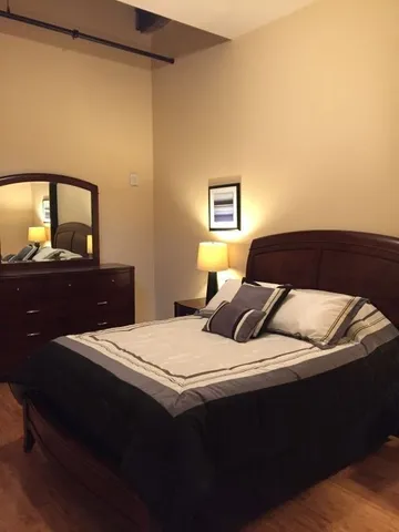 a bedroom with a bed and a dresser